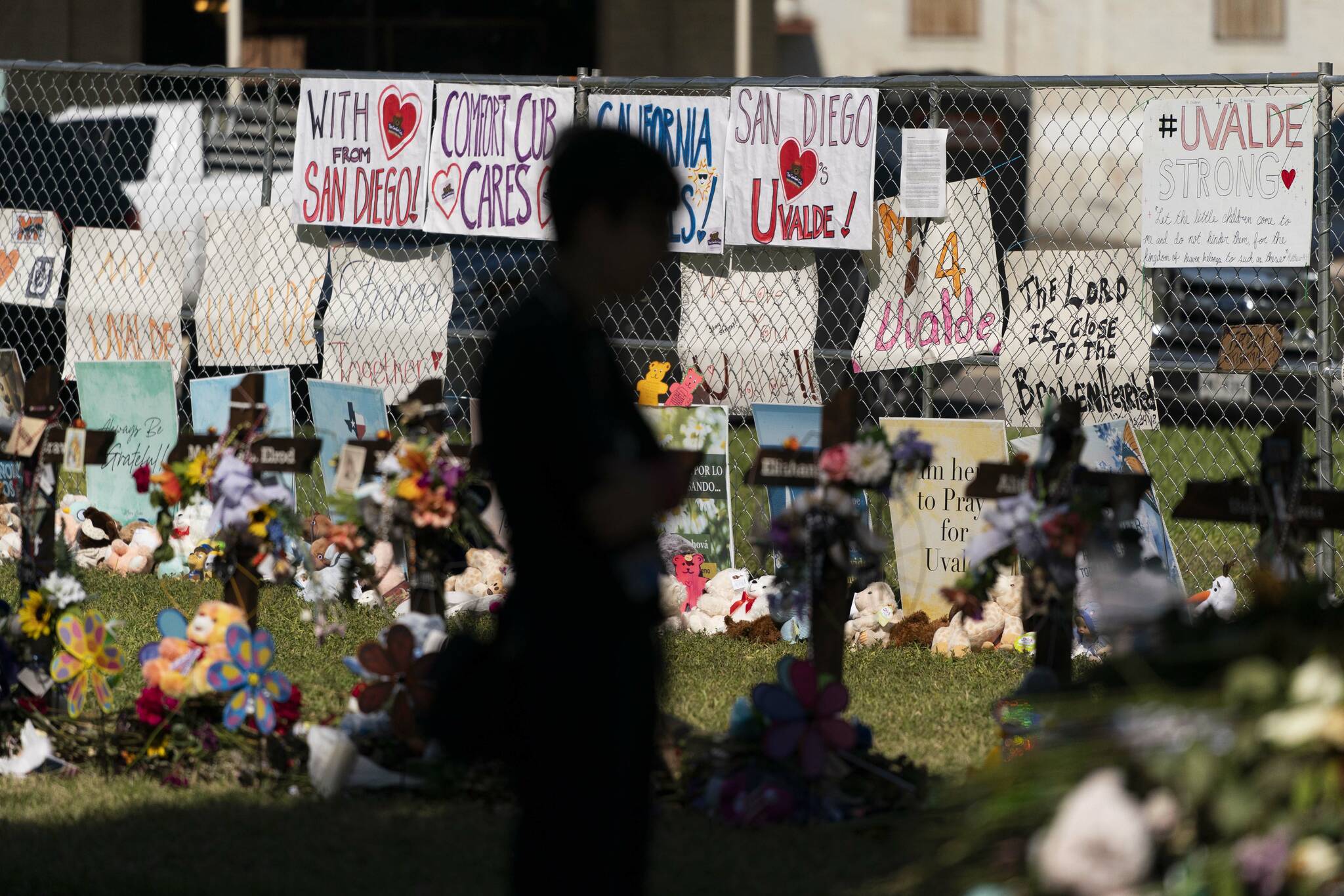 A woman visits a memorial honoring the victims killed in last week’s elementary school shooting in Uvalde, Texas, Friday, June 3, 2022. It’s hard to say exactly when some Texas educators began to feel like they were under siege, but the massacre of 19 students and two teachers at Robb Elementary School is only the latest, horrific episode in a string of events dating back years. (AP Photo/Jae C. Hong)