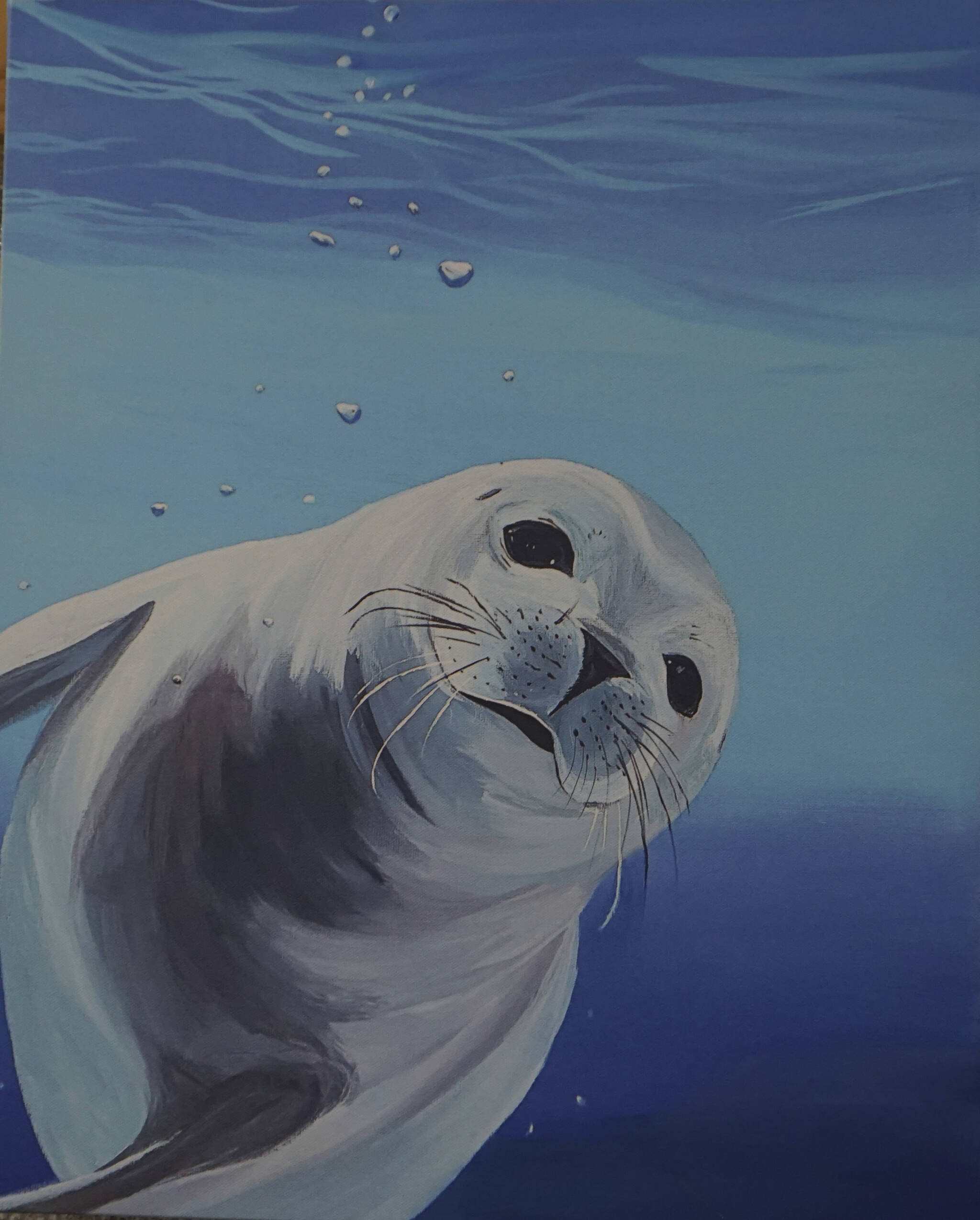 This print of “Sealin’ Around” was made from a painting Tarryn Zebrinos donated to the Alaska SeaLife Center. (Photo by Michael Armstrong/Homer News)
