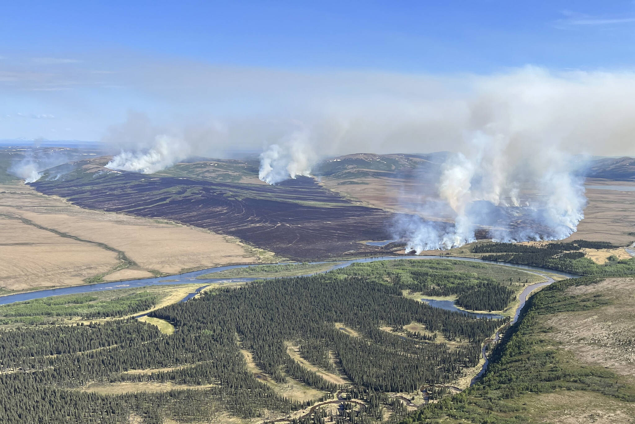 In this aerial photo provided by the BLM Alaska Fire Service, the East Fork Fire burns about 25 miles north of St. Mary’s, Alaska on June 2. The largest documented wildfire ever burning through tundra in southwest Alaska is within miles of two Alaska Native villages, prompting dozens of residents with respiratory problems to voluntarily evacuate. (Pat Johnson, BLM Alaska Fire Service via AP)