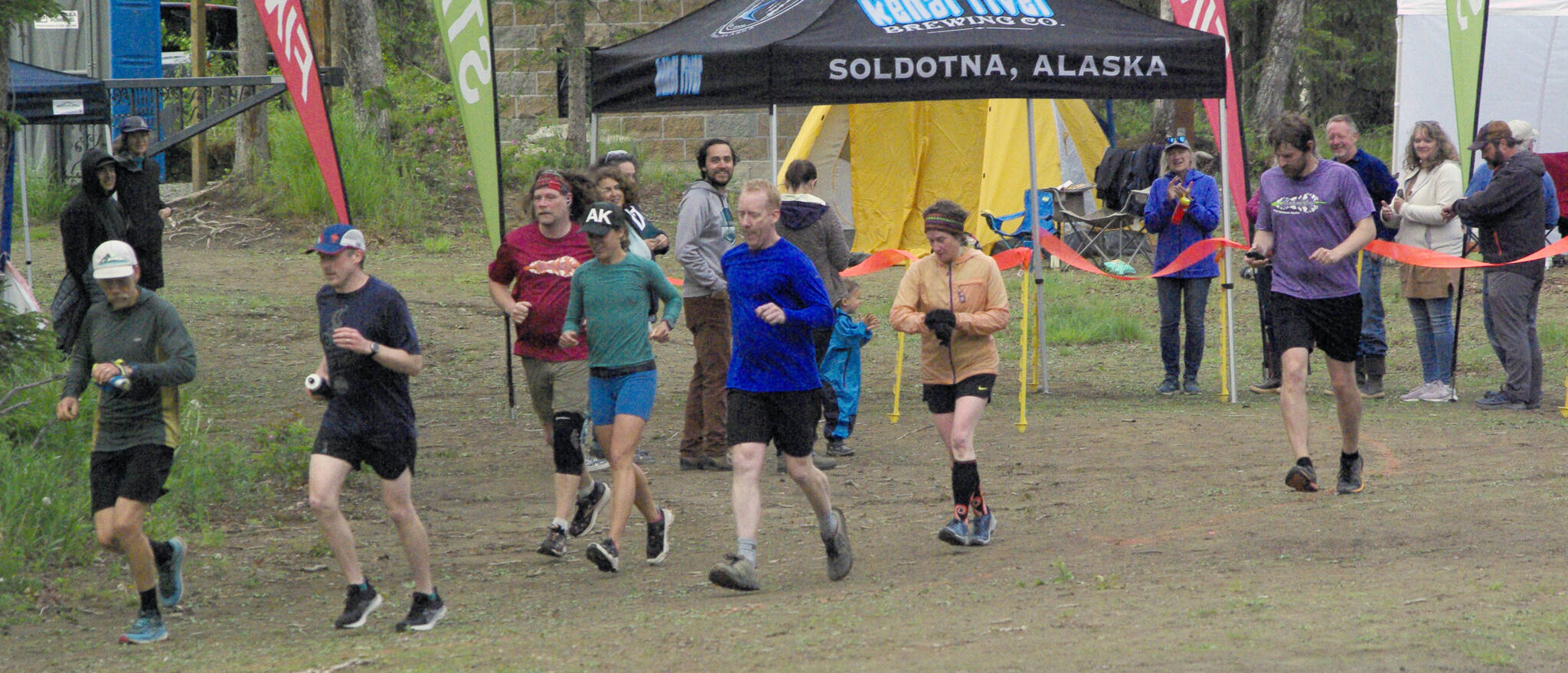 The seven runners left in the Tsalteshi Backyard Ultra ѠDave Short, Zach Behney, Sean Goff, Carrie Setian, Kent Peterson, Yvonne Leutwyler and Rustin Hitchcock Ѡtake off on their fifth lap of the 4.167-mile loop Friday at 9 p.m. Runners will keep doing the loop each hour until only the winner remains. The winner gets a ticket to the Tartarus Backyard Ultra in Spokane, Washington, on July 30. There were 15 runners at the start of the Tsalteshi Backyard Ultra. (Photo by Jeff Helminiak/Peninsula Clarion)