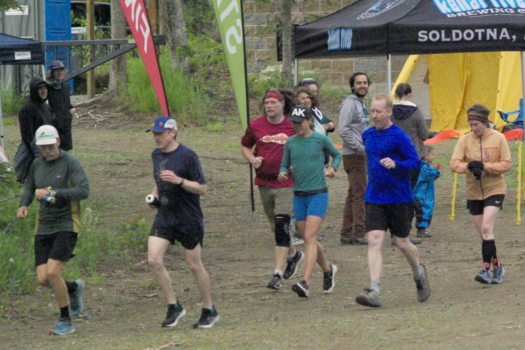 The seven runners left in the Tsalteshi Backyard Ultra ѠDave Short, Zach Behney, Sean Goff, Carrie Setian, Kent Peterson, Yvonne Leutwyler and Rustin Hitchcock Ѡtake off on their fifth lap of the 4.167-mile loop Friday at 9 p.m. Runners will keep doing the loop each hour until only the winner remains. The winner gets a ticket to the Tartarus Backyard Ultra in Spokane, Washington, on July 30. There were 15 runners at the start of the Tsalteshi Backyard Ultra. (Photo by Jeff Helminiak/Peninsula Clarion)