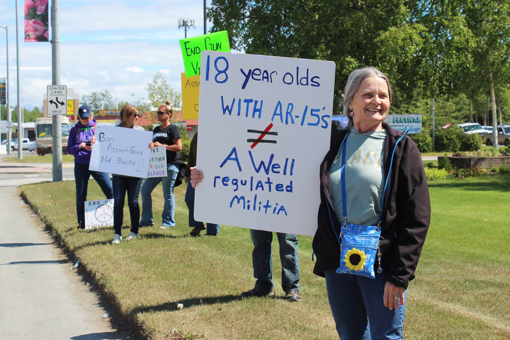 Fay Herold of Seward holds a sign during a demonstration opposing gun violence on Saturday, June 11, 2022, in Soldotna, Alaska. The local protest was part of a nationwide call to action issued by the nonprofit organization March for Our Lives, which was formed after a 2018 school shooting in Parkland, Florida, and aims to end gun violence. (Ashlyn O’Hara/Peninsula Clarion)