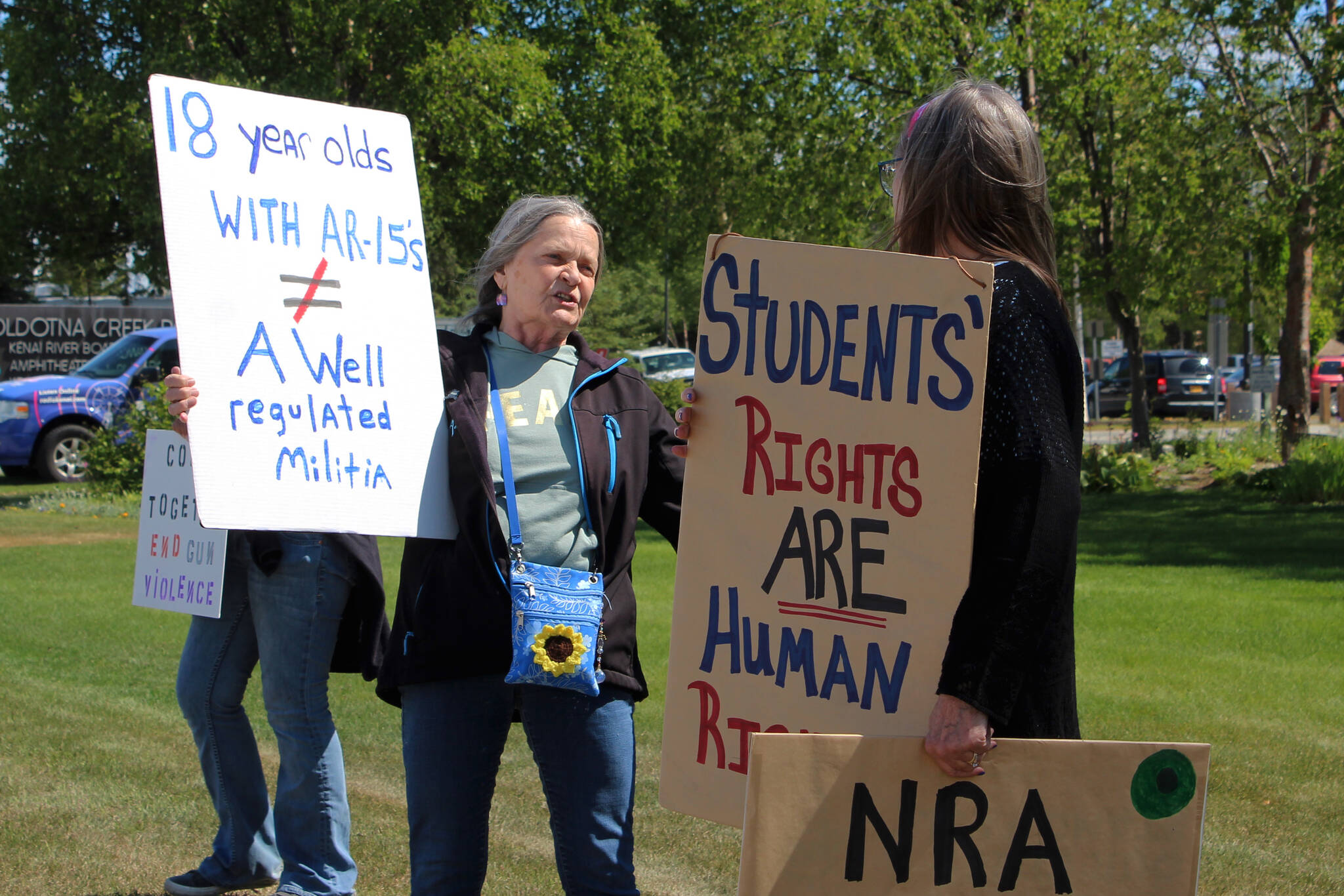 Fay Herold, left, and Michele Vasquez hold signs during a demonstration opposing gun violence on Saturday, June 11, 2022, in Soldotna, Alaska. The local protest was part of a nationwide call to action issued by the nonprofit organization March for Our Lives, which was formed after a 2018 school shooting in Parkland, Florida, and aims to end gun violence. (Ashlyn O’Hara/Peninsula Clarion)