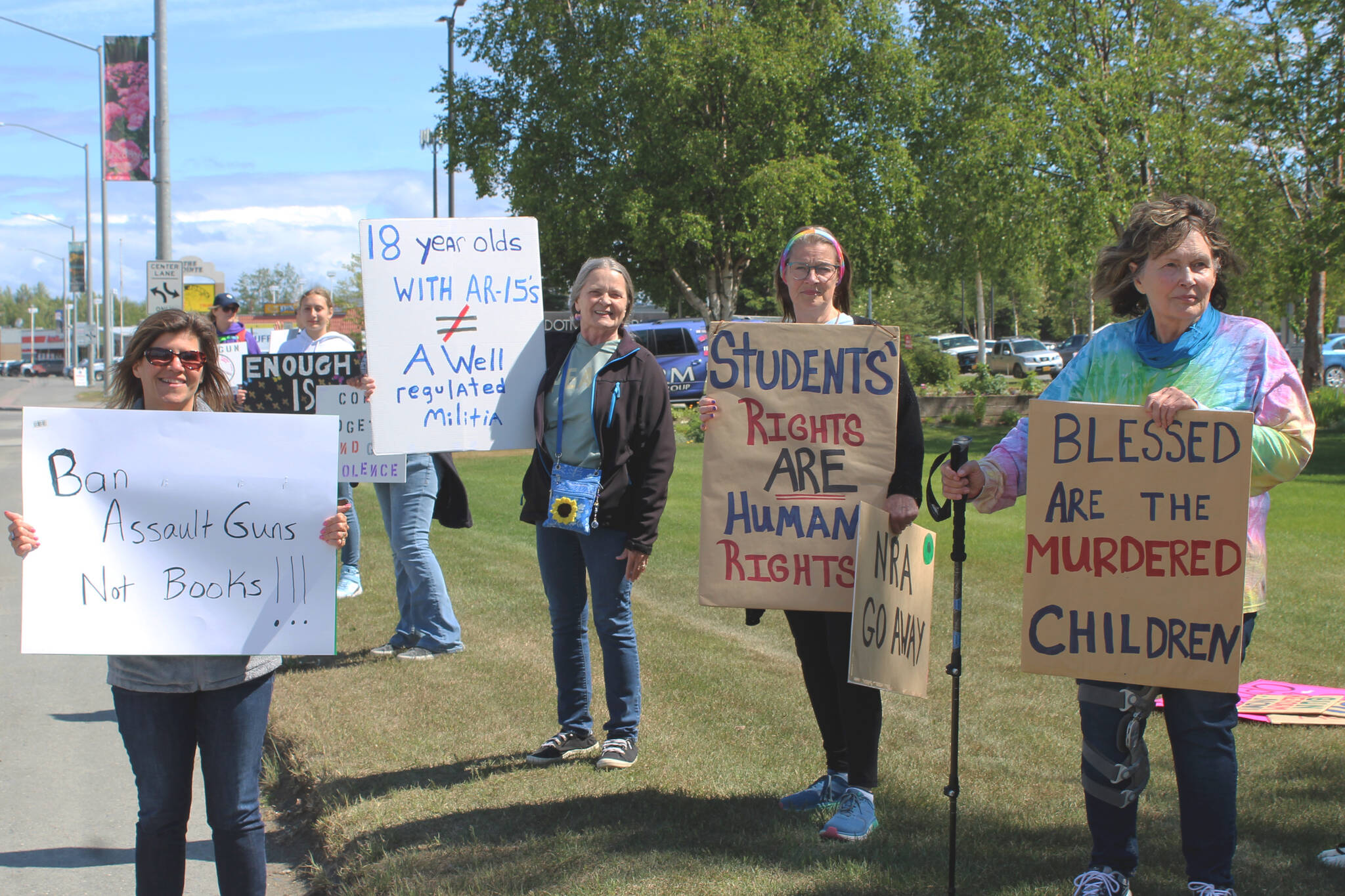 People hold signs during a demonstration opposing gun violence on Saturday, June 11, 2022 in Soldotna, Alaska. The local protest was part of a nationwide call to action issued by the nonprofit organization March for Our Lives, which was formed after a 2018 school shooting in Parkland, Florida and aims to end gun violence. (Ashlyn O'Hara/Peninsula Clarion)