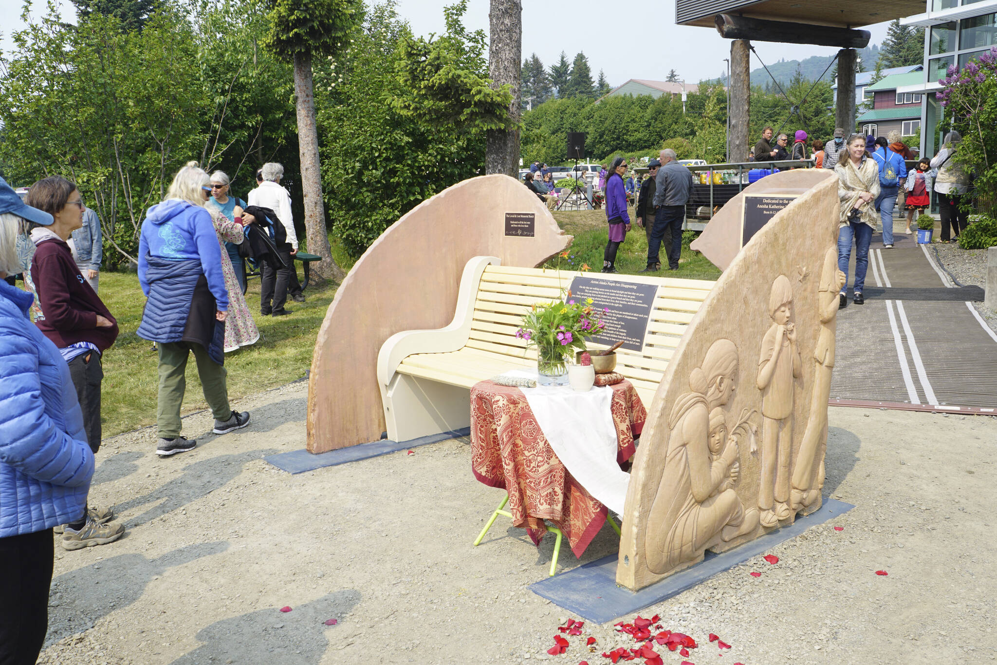 People visit at the Loved & Lost Memorial Bench on Sunday, June 12, 2022, at the Homer Public Library in Homer, Alaska, for a memorial for Anesha “Duffy” Murnane and the dedication of the bench. (Photo by Michael Armstrong/Homer News)