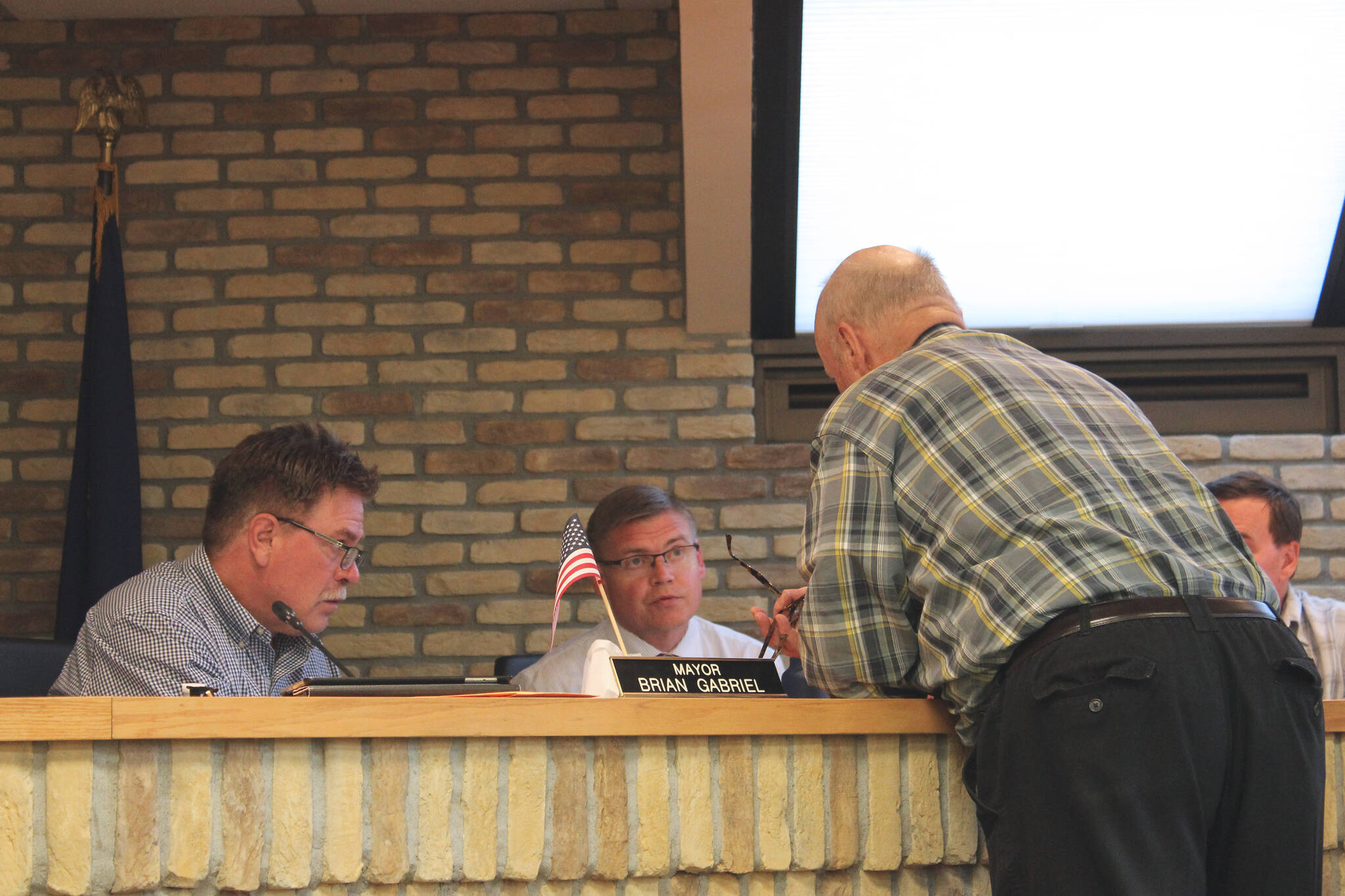 From left: Kenai Mayor Brian Gabriel, Kenai City Manager Paul Ostrander and Kenai Vice Mayor Jim Glendening discuss legislation during an at-ease at a council meeting on Wednesday, June 15, 2022, in Kenai, Alaska. (Ashlyn O’Hara/Peninsula Clarion)