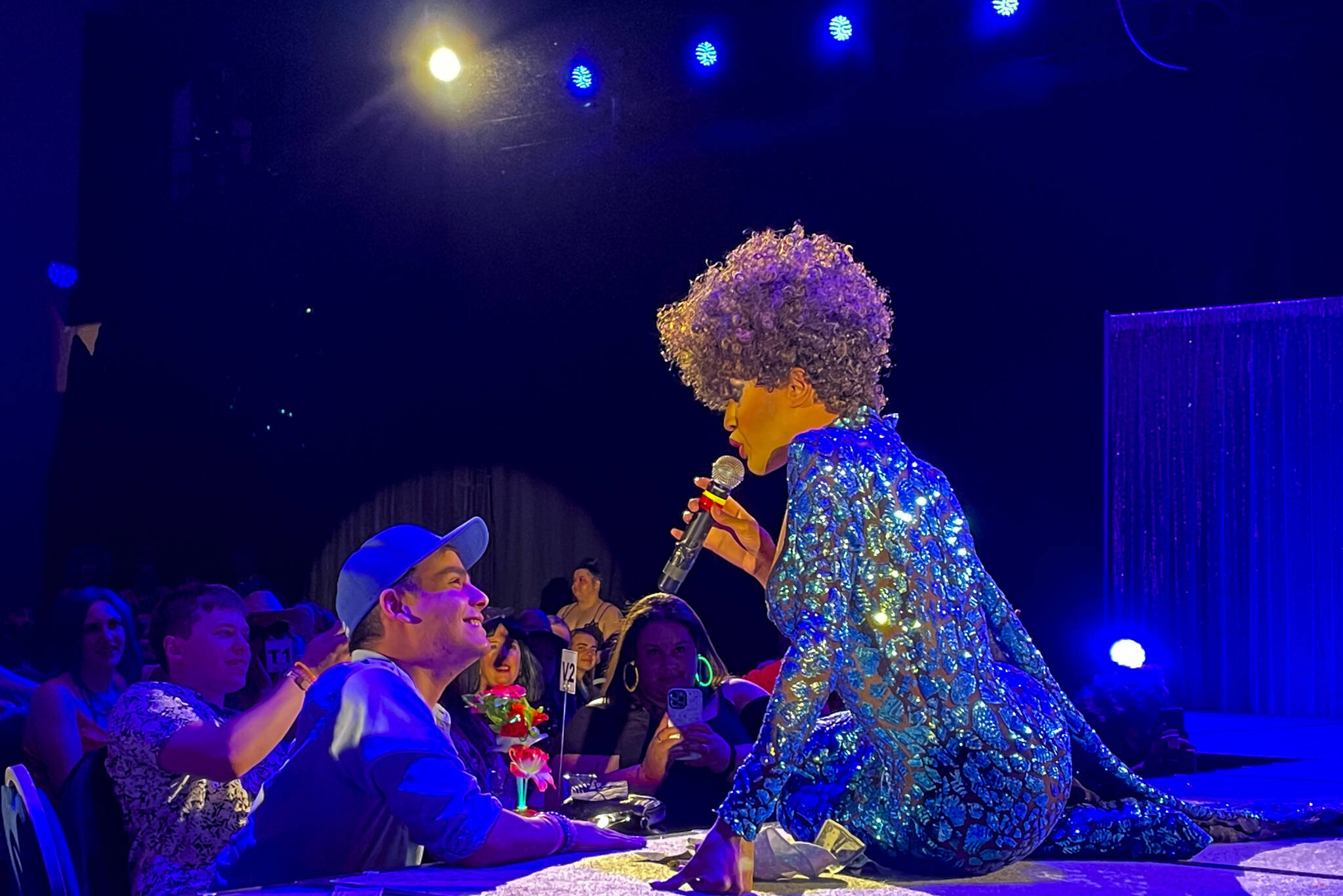 Trinity K. Bonet, one of the headliners, sings to a member of the audience during Glitz, a major annual drag event celebrated every Pride Month, at Centennial Hall on June 18, 2022. (Michael S. Lockett / Juneau Empire)