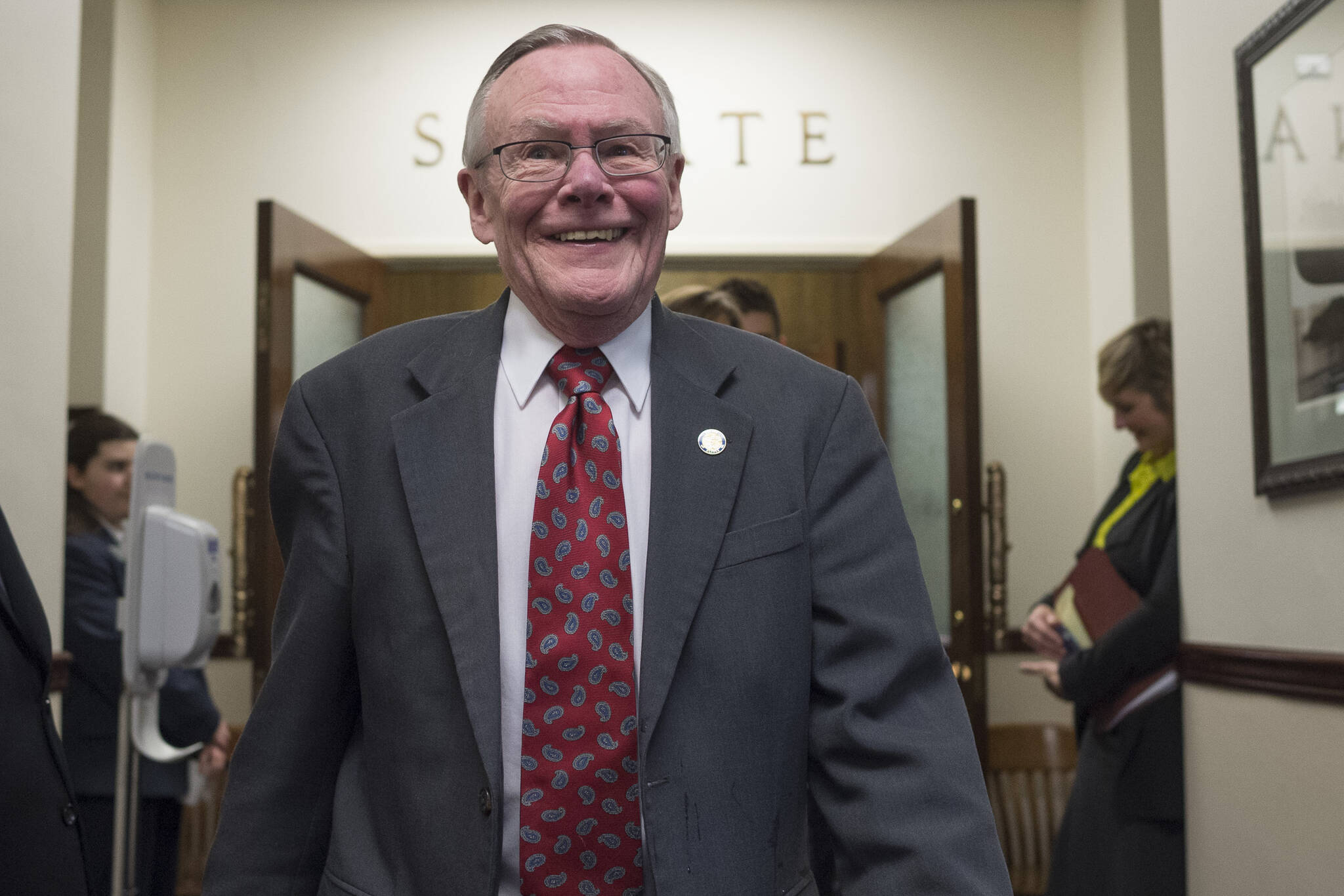 In this April 11, 2018 photo state Sen. Dennis Egan, D-Juneau, walks out of the Senate chambers and to a reception to honor him and Sen. Berta Gardner, D-Anchorage, at the Capitol. Both were retiring from the legislature. (Michael Penn / Juneau Empire File)