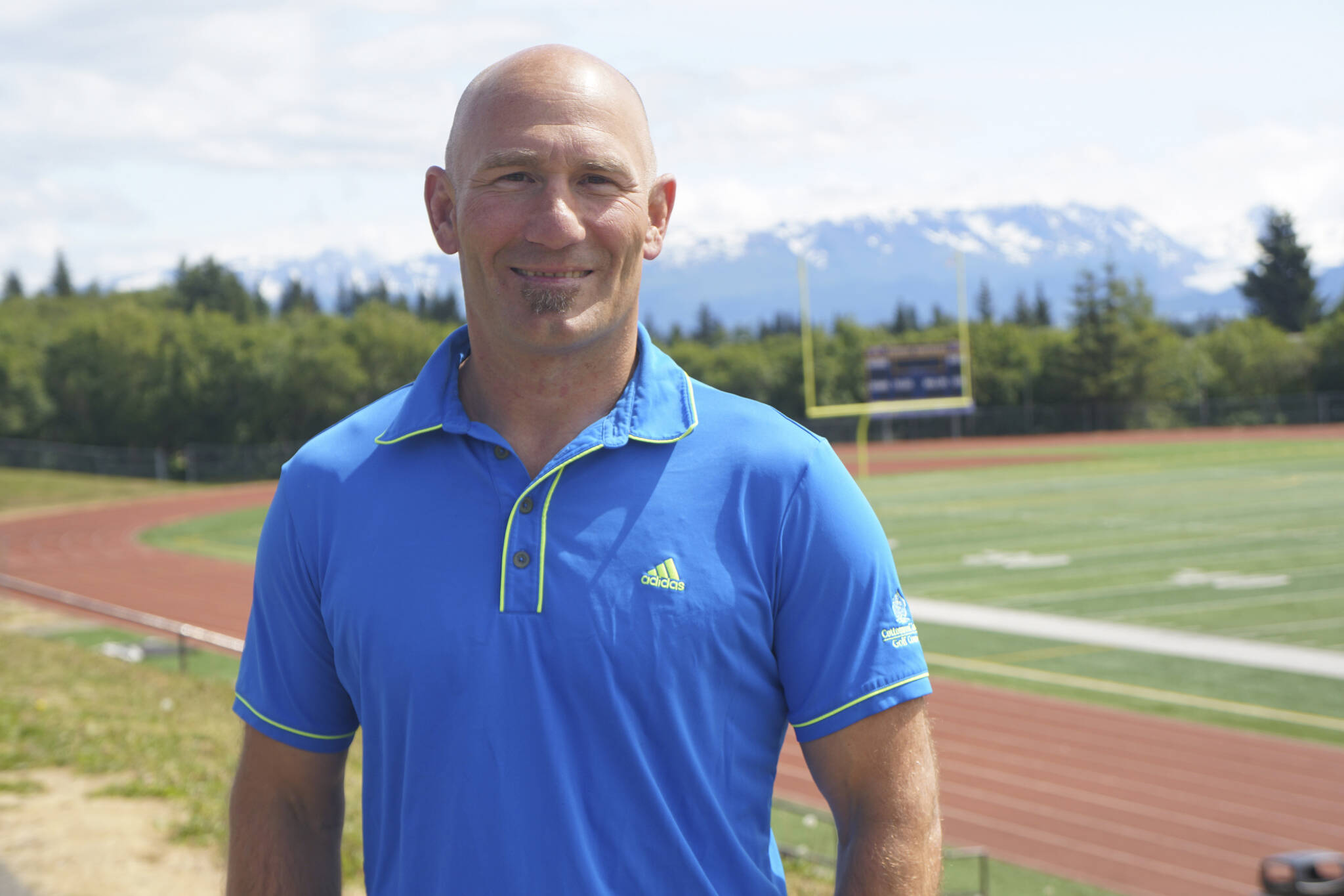 Former Homer High School athletic director poses on Friday, July 1, 2022, at the high school athletic field in Homer, Alaska. (Photo by Michael Armstrong/Homer News)