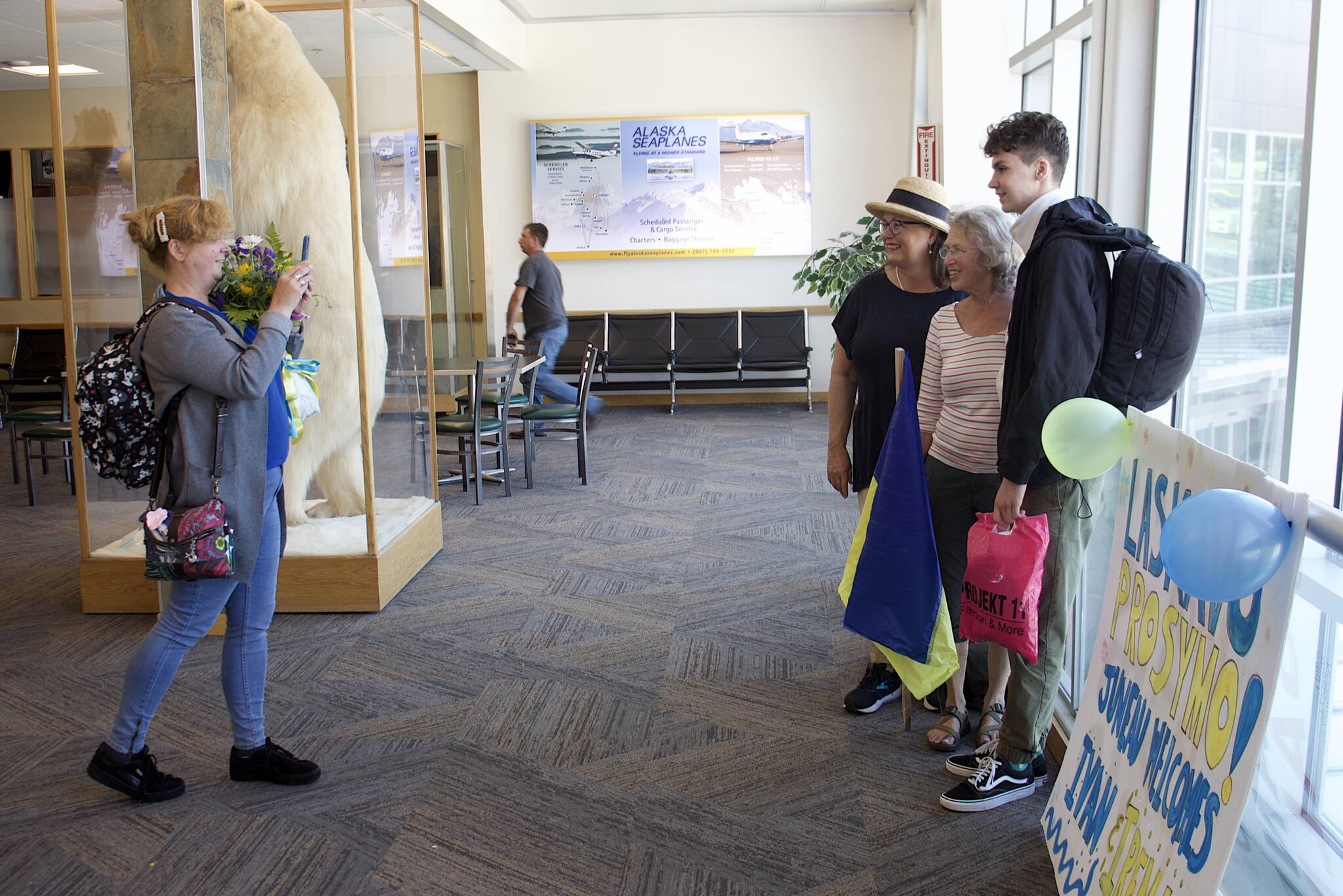 Mark Sabbatini / Juneau Empire
Iryna Hrynchenko takes a photo of Bridget Smith, Joyanne Bloom and Hrynchenko’s 18-year-old son Ivan inside Juneau International Airport on Saturday, June 25, 2022.