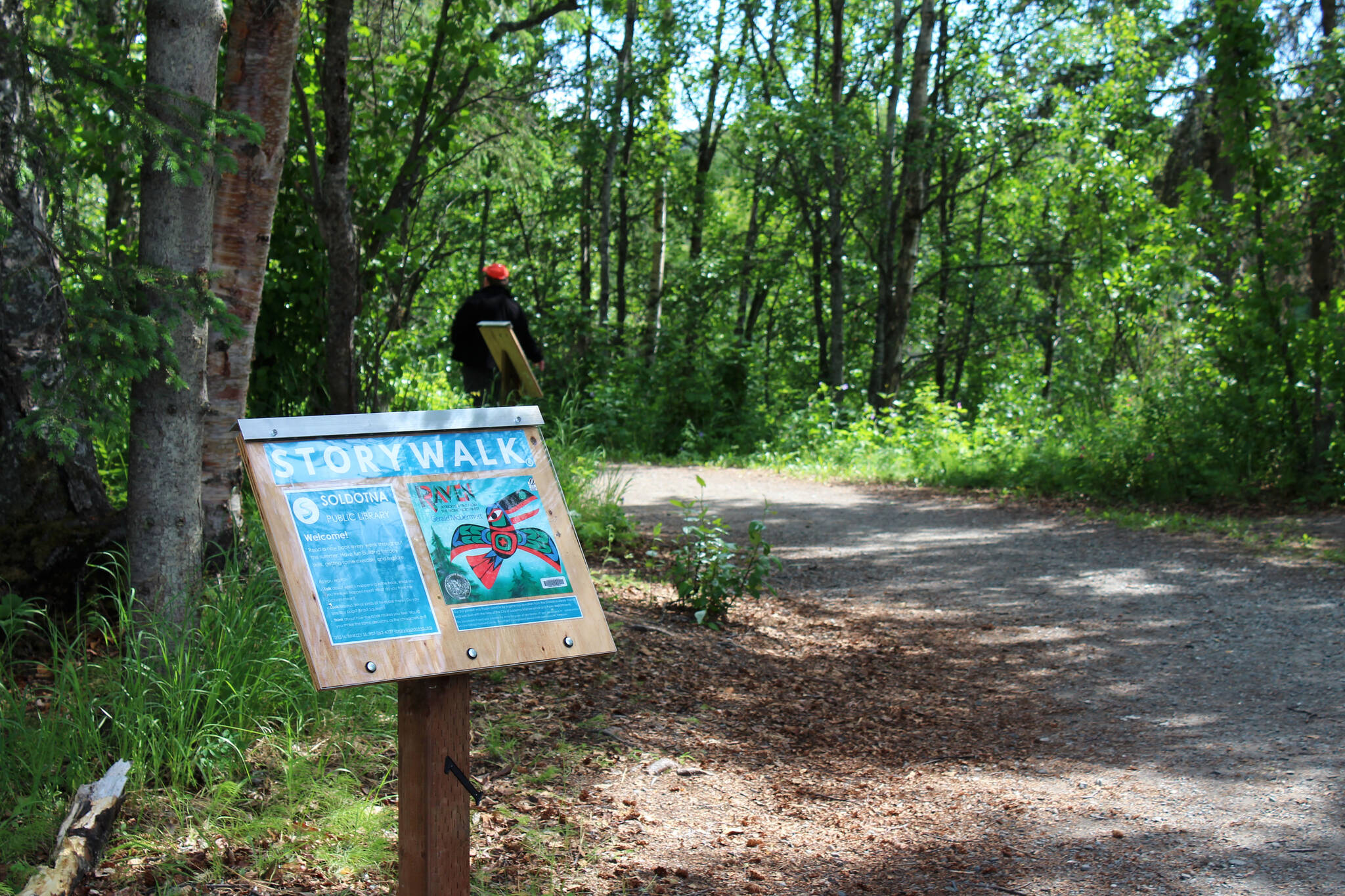 A podium marks the beginning of a StoryWalk at Soldotna Creek Park on Tuesday, June 29, 2021, in Soldotna, Alaska. (Ashlyn O’Hara/Peninsula Clarion)