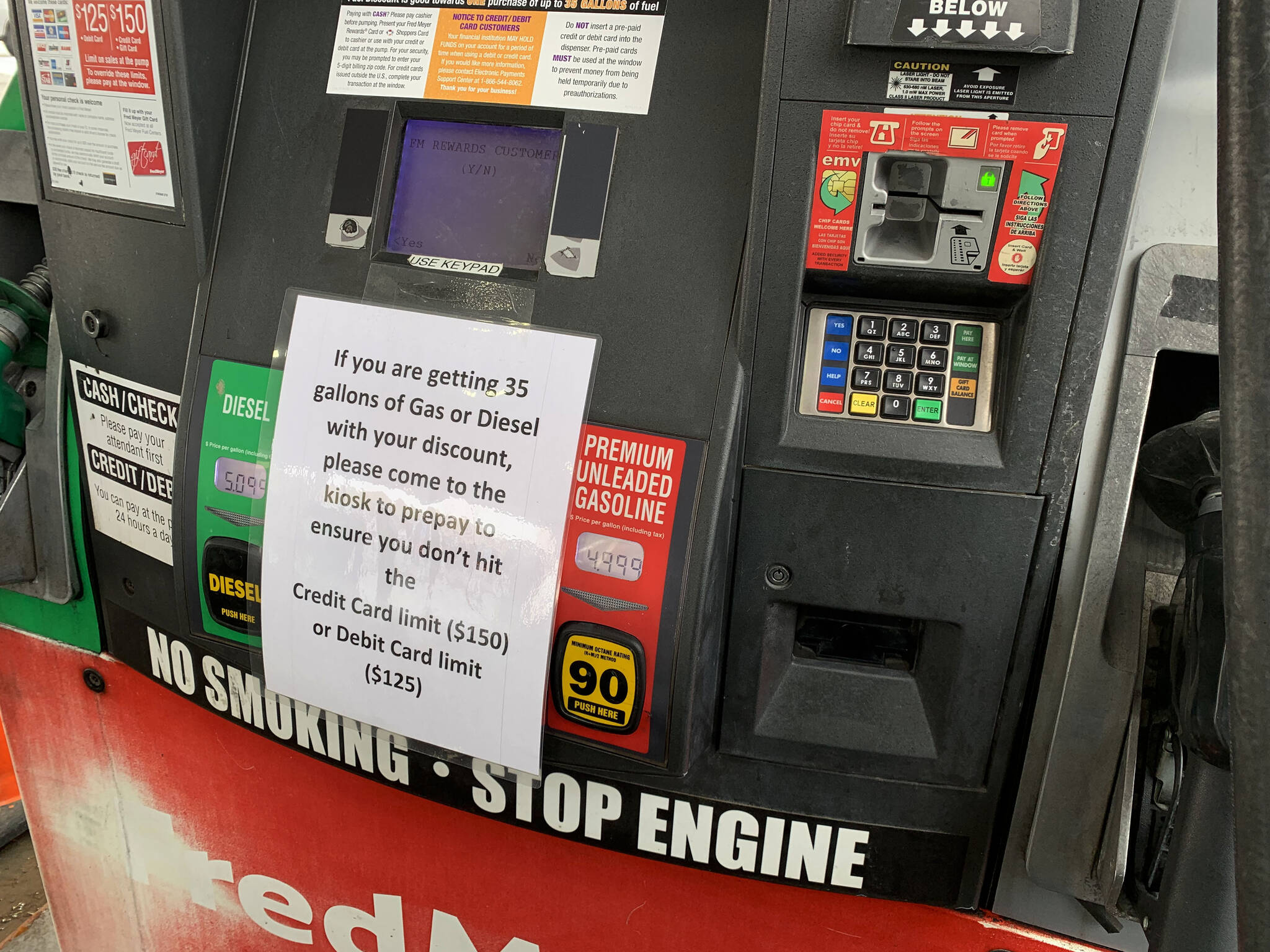 Signs warn Fred Meyer customers to prepay if they thing they may go over limits while pumping gas on Friday, March 11, 2022 in Soldotna, Alaska. (Ashlyn O’Hara/Peninsula Clarion)