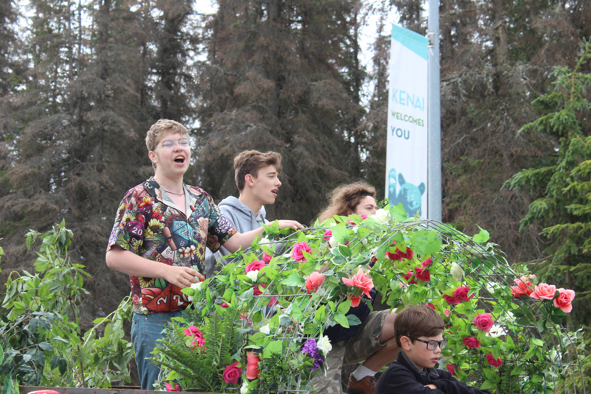 The cast of the Disney musical “Tarzan,” which is being performed at Soldotna Creek Park beginning Saturday, rides the Triumvirate Theatre float during the Kenai 4th of July Parade on Monday, July 4, 2022, in Kenai, Alaska. (Camille Botello/Peninsula Clarion)