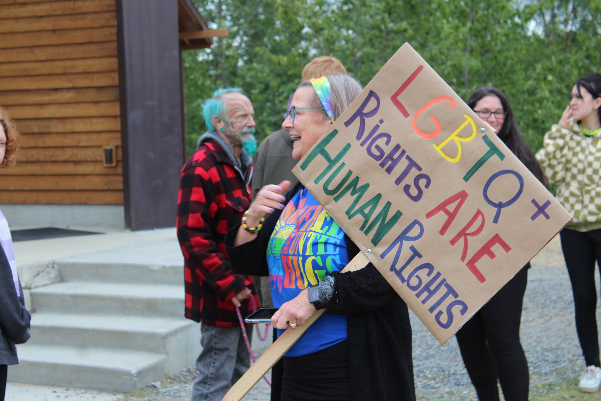 Community members gather in Soldotna on Friday, June 17, 2022 to celebrate Pride month. People marched from the Soldotna Sports Complex to Soldotna Creek Park donned in rainbow-colored attire and wielding flags and signs supporting the LGBTQI+ cause. Waiting at the park were people with different advocacy and resource agencies, as well as entertainment and refreshments. (Camille Botello/Peninsula Clarion)