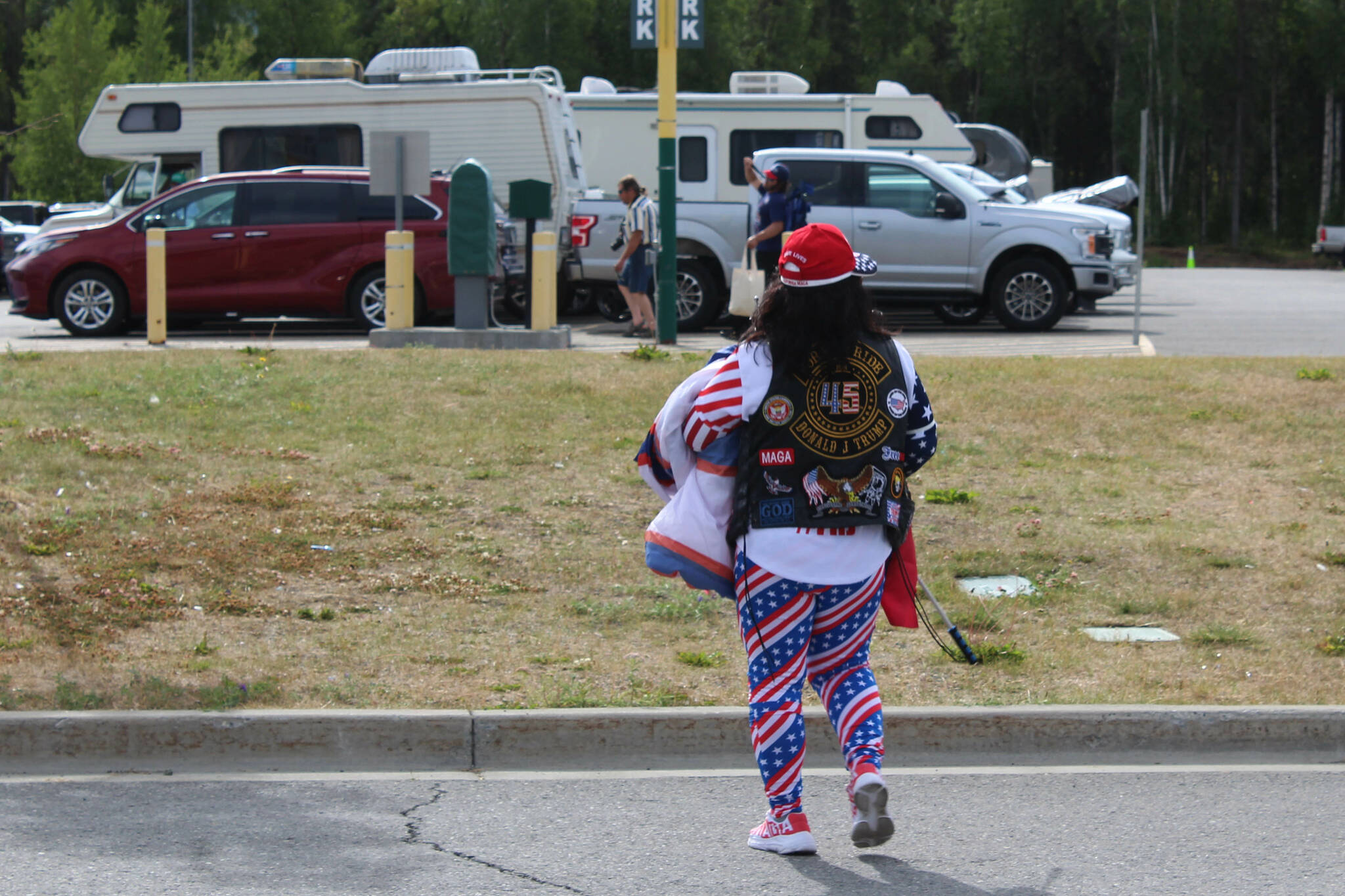 A person wearing Donald Trump and patriotic attire walks around outside of the Alaska Airlines Center, where a Save America rally was being held, on Saturday, July 9, 2022, in Anchorage, Alaska. Former President Donald Trump, U.S. Senate candidate Kelly Tshibaka and U.S. House candidate Sarah Palin were among the event’s speakers. (Ashlyn O’Hara/Peninsula Clarion)