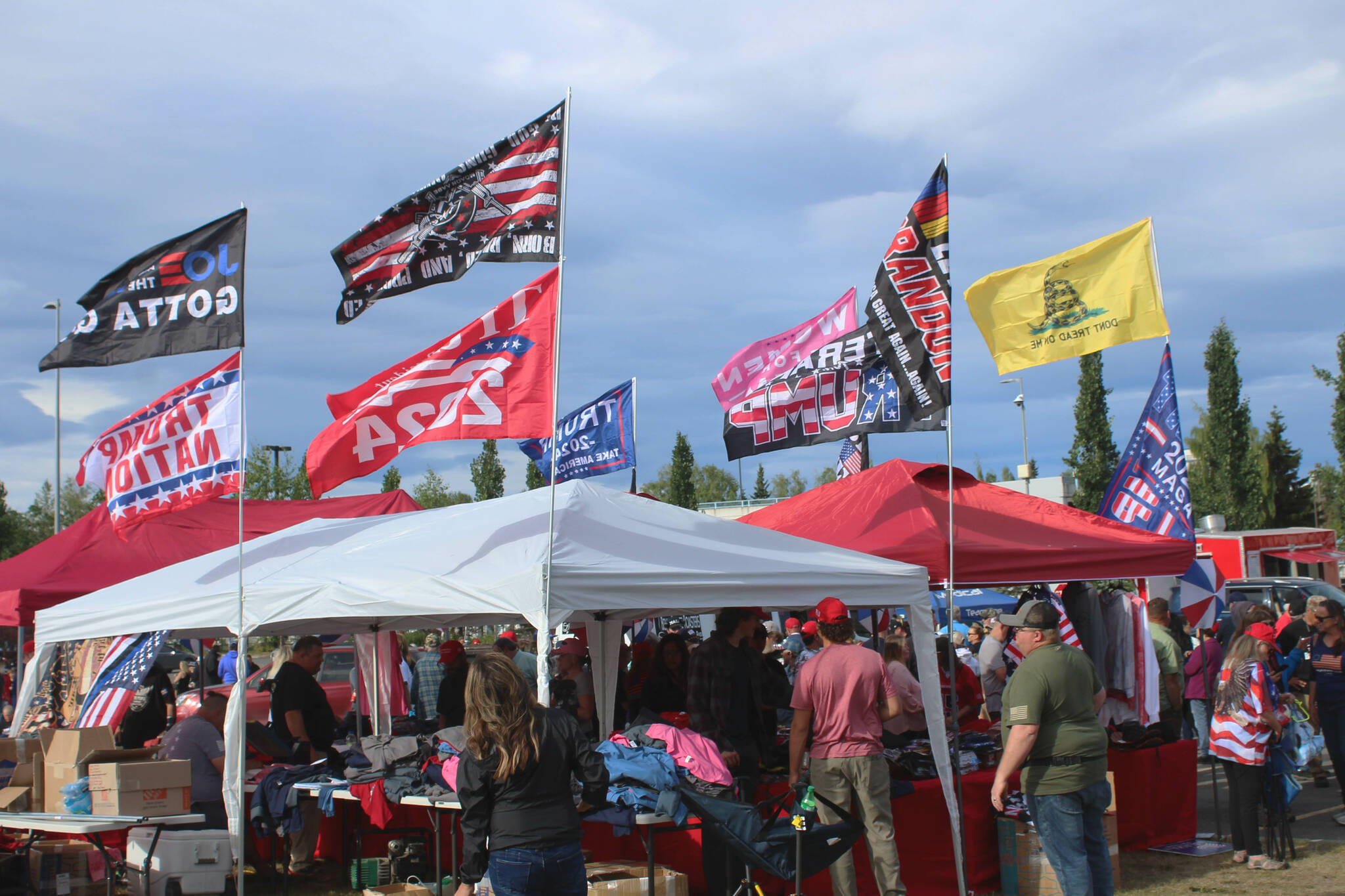 Vendors sell flags and other merchandise outside of the Alaska Airlines Center, where a Save America rally was being held, on Saturday, July 9, 2022, in Anchorage, Alaska. Former President Donald Trump, U.S. Senate candidate Kelly Tshibaka and U.S. House candidate Sarah Palin were among the event’s speakers. (Ashlyn O’Hara/Peninsula Clarion)