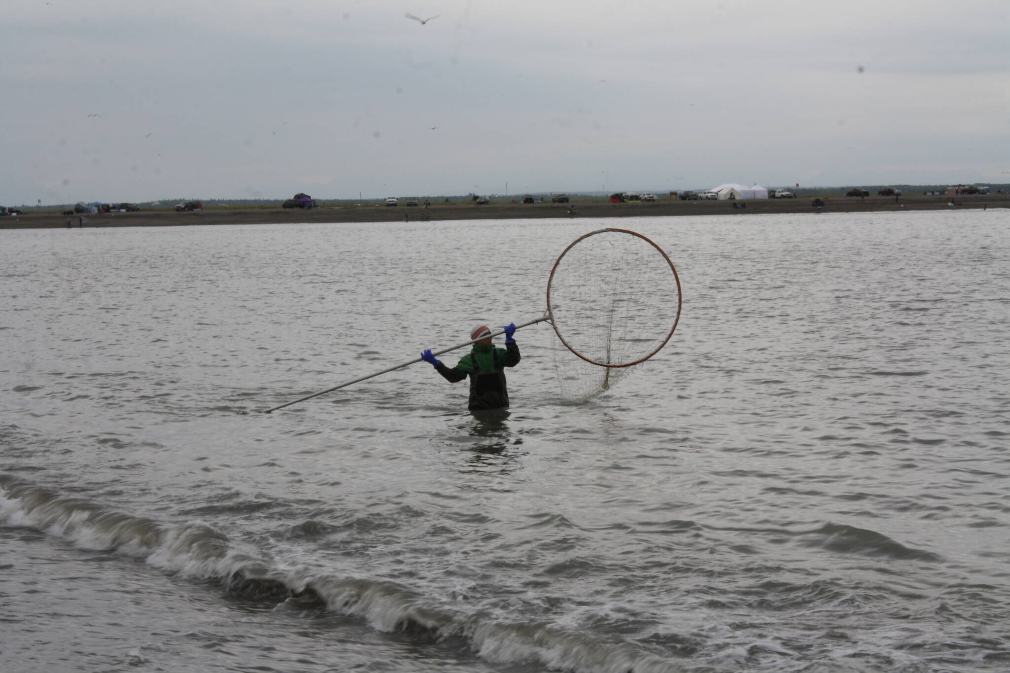 A dipnetter fishes at North Kenai Beach on Tuesday, July 12, 2022. (Camille Botello/Peninsula Clarion)