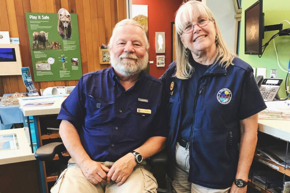 Gail and Bill smile from their summer volunteer position at the Refuge Visitor Center front desk. (Photo provided by refuge)