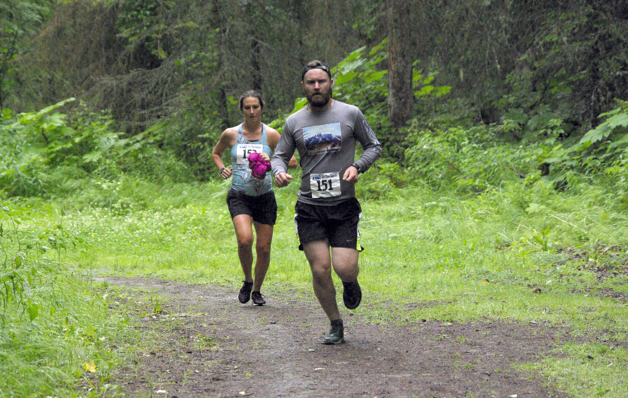 James Butler leads Madison Labosky at the Unity Run on Saturday, July 16, 2022, at Tsalteshi Trails just outside of Soldotna, Alaska. Butler won the men’s 10-kilometer race, while Labosky won the women’s 5-kilometer race. (Photo by Jeff Helminiak/Peninsula Clarion)