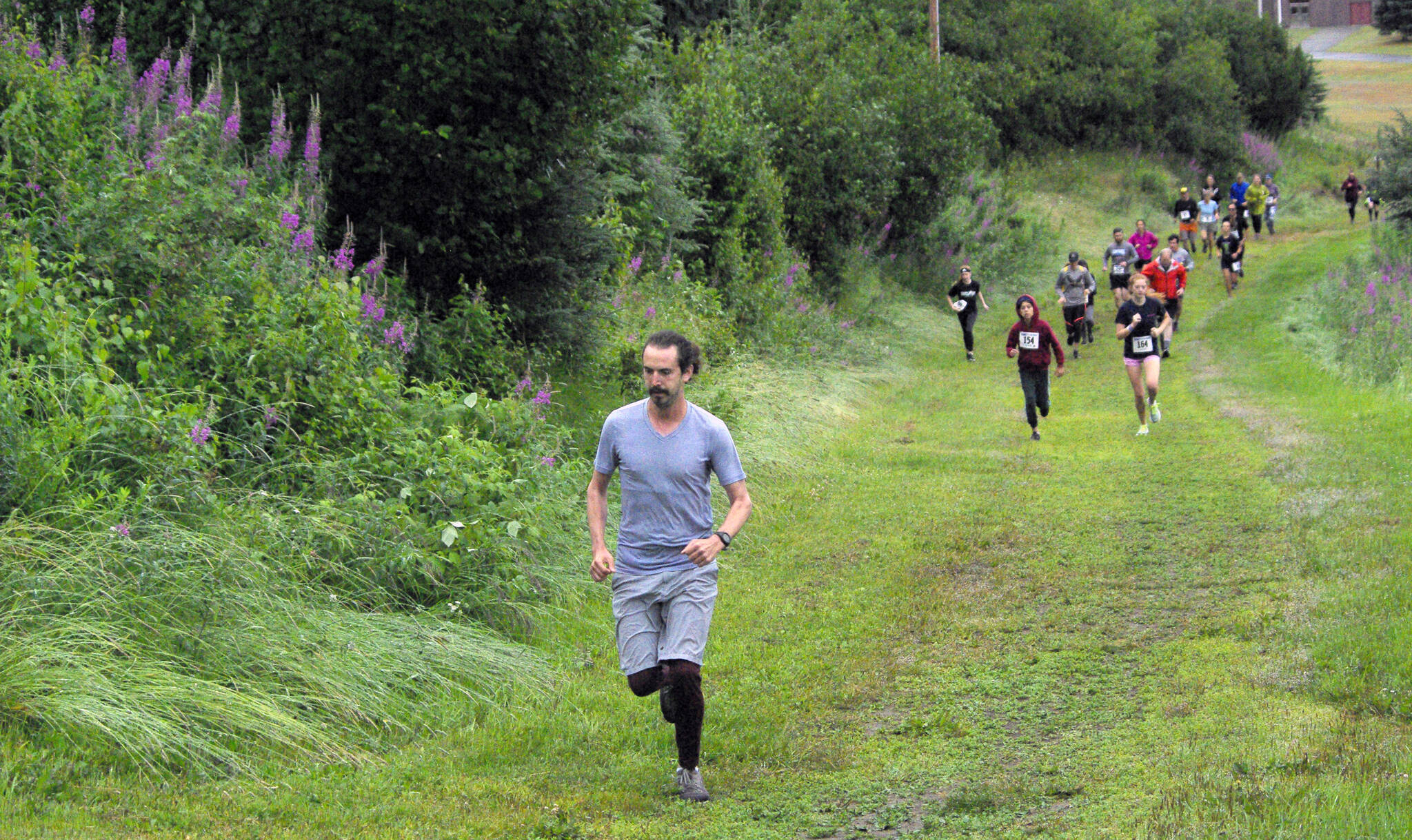 Competitors start the Unity Run on Saturday, July 16, 2022, at Tsalteshi Trails just outside of Soldotna, Alaska. (Photo by Jeff Helminak/Peninsula Clarion)