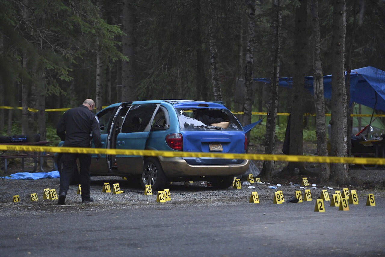 Evidence markers are placed around the scene of a shooting in Centennial Park campground in Anchorage, Alaska, Wednesday, July 20, 2022. (Bill Roth/Anchorage Daily News via AP)