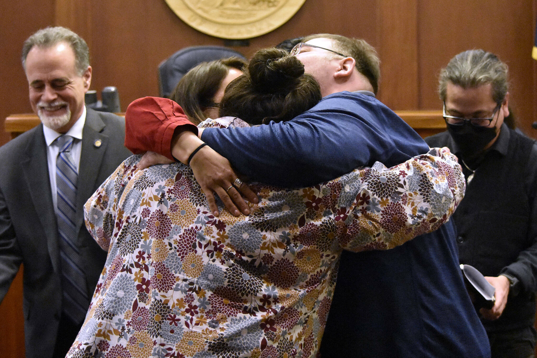 Alaskans for Better Government members La quen náay Liz Medicine Crow, Richard Chalyee Éesh Peterson and ‘Wáahlaal Gidáak Barbara Blake embrace on the floor of the Alaska State Senate on Friday, May 13, 2022, following the passage of House Bill 123, a bill to formally recognize the state’s 229 already federally-recognized tribes. Gov. Mike Dunleavy is scheduled to sign the bill during a ceremony Thursday during a ceremony in Anchorage. (Peter Segall / Juneau Empire)