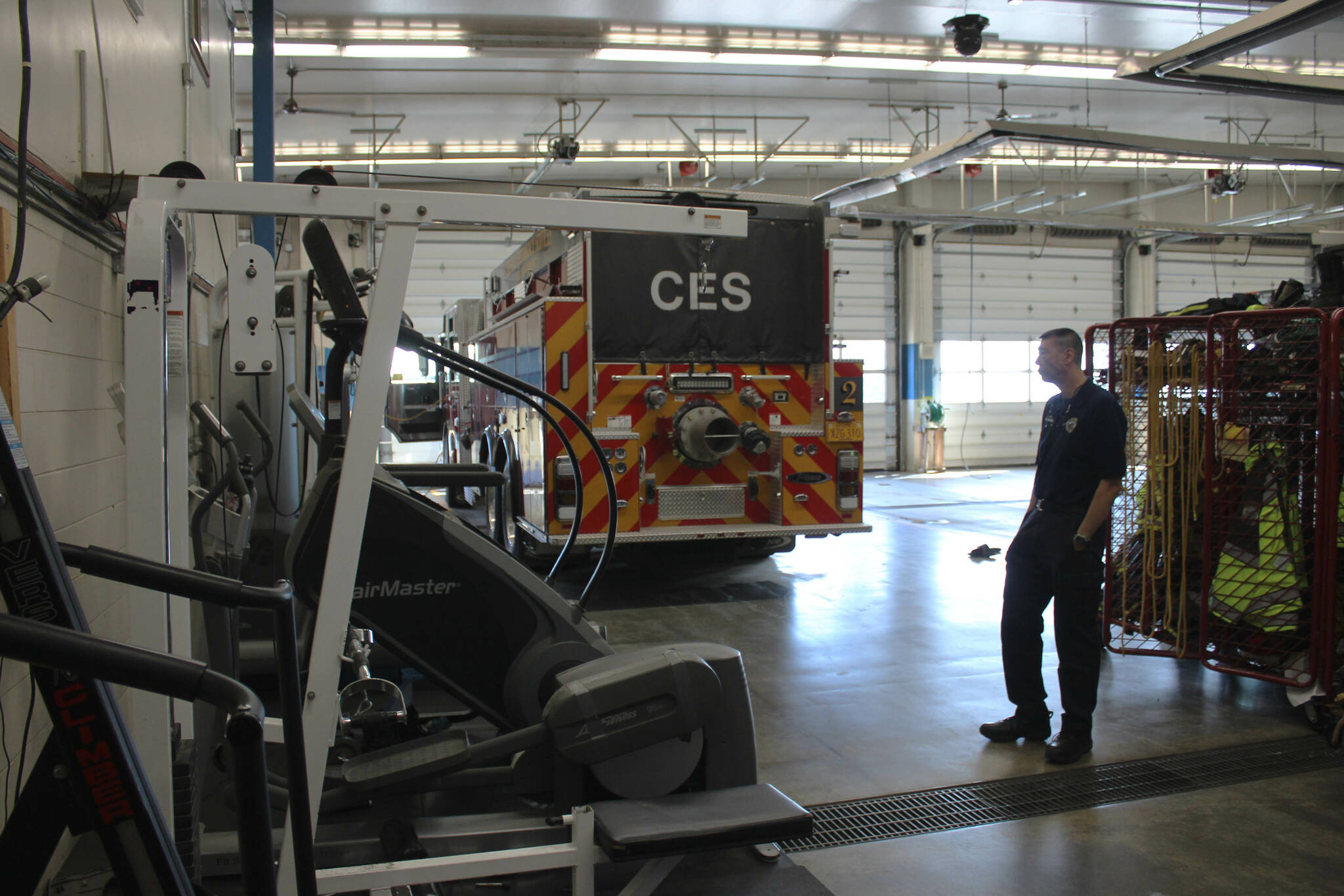 Central Emergency Services Fire Chief Roy Browning stands amid cardio equipment and firefighter lockers in the agency’s vehicle bay on Tuesday, July 26, 2022, in Soldotna, Alaska. (Ashlyn O’Hara/Peninsula Clarion)