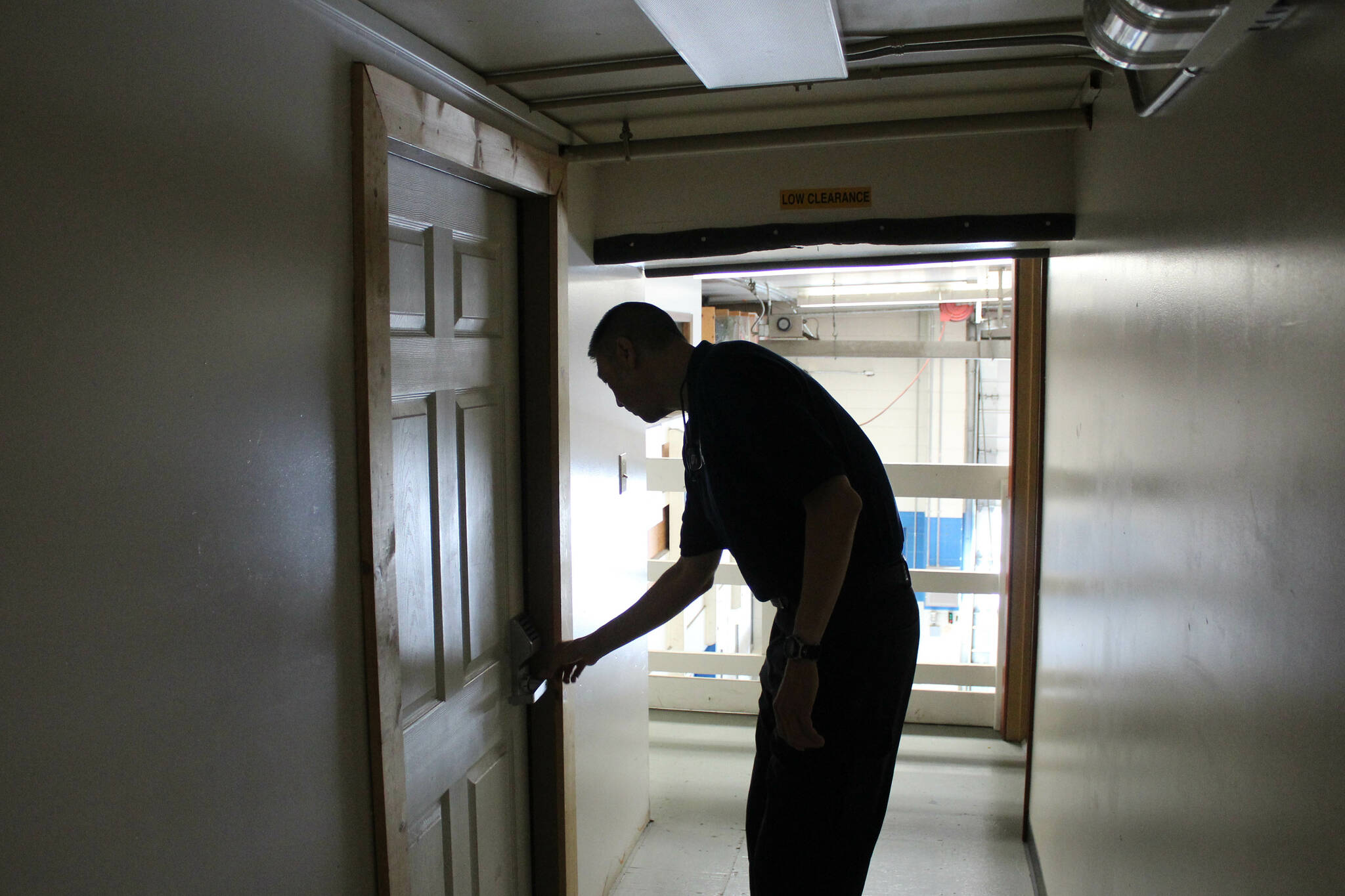 Central Emergency Services Fire Chief Roy Browning stoops to access one of the agency’s supply rooms on Tuesday, July 26, 2022, in Soldotna, Alaska. (Ashlyn O’Hara/Peninsula Clarion)