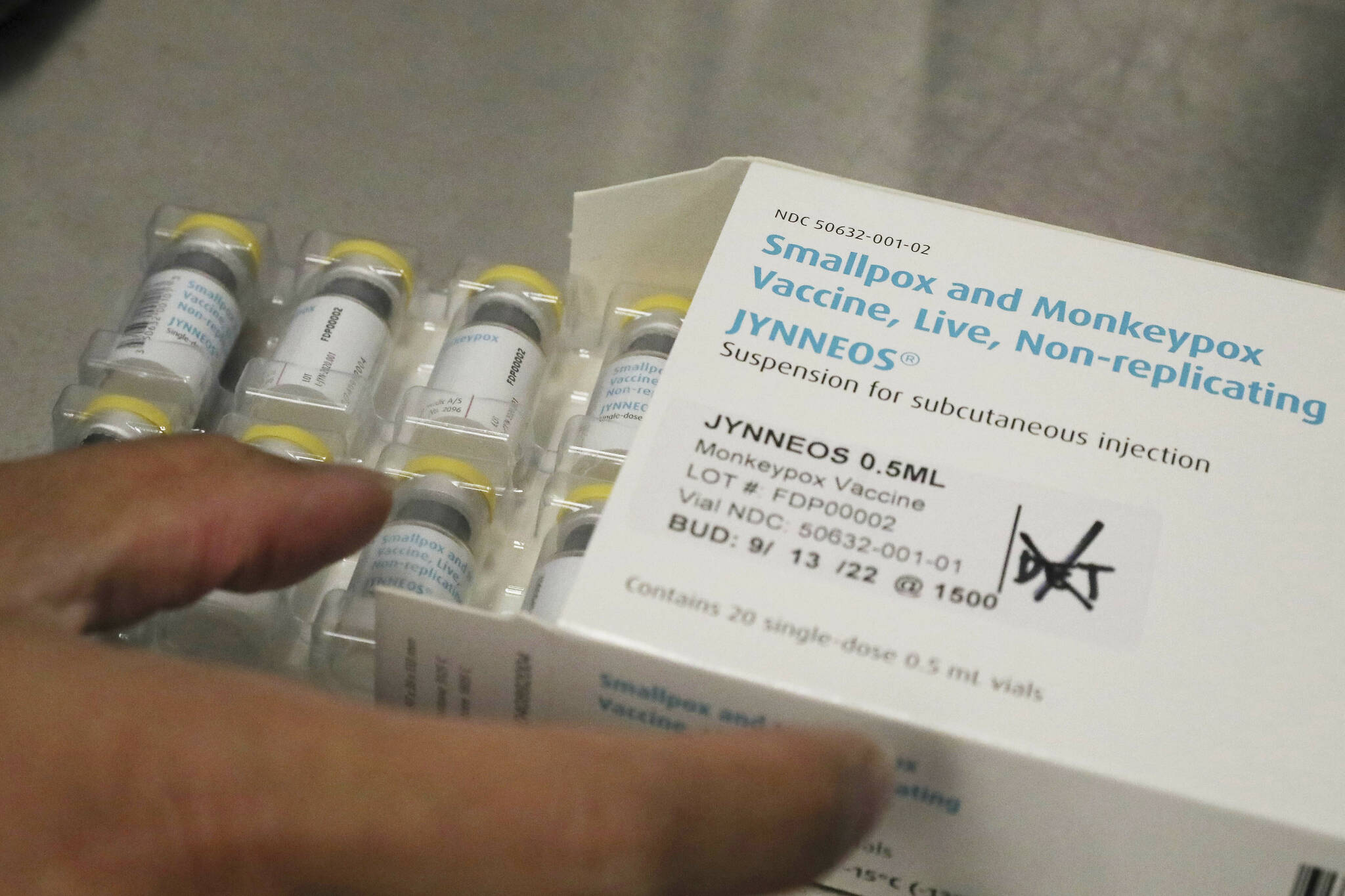 Jonathan Parducho, a pharmacist, removes a tray of vials of of the Jynneos vaccine for monkeypox from a box containing 20 doses, in the vaccine hub at Zuckerberg San Francisco General Hospital on Friday, July 29, 2022, in San Francisco. (Lea Suzuki/San Francisco Chronicle via AP)