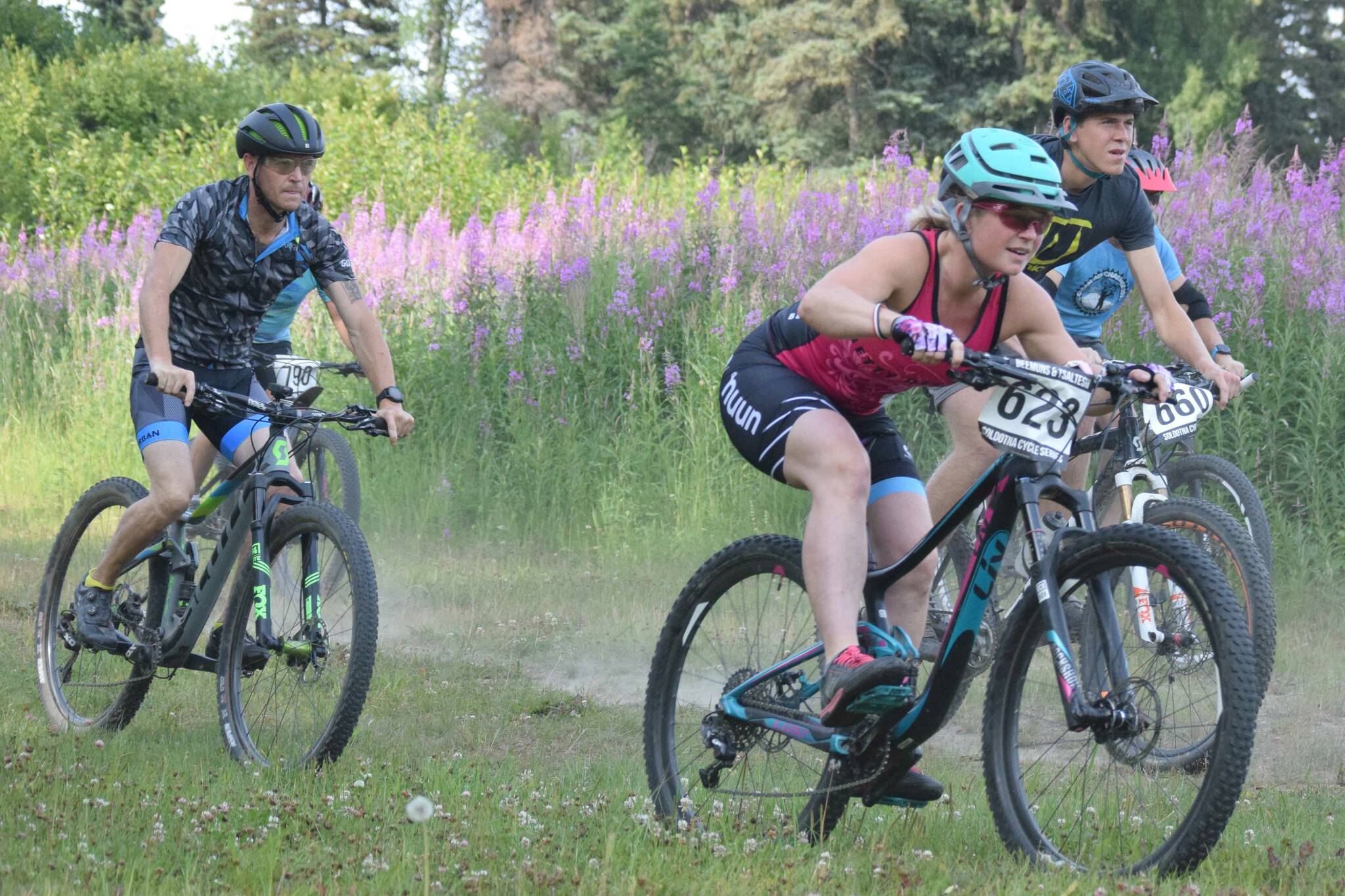 Morgan Aldridge leads riders down a hill at the start of Week 3 of the Soldotna Cycle Series on Thursday, July 18, 2019, at Tsalteshi Trails. (Photo by Jeff Helminiak/Peninsula Clarion)