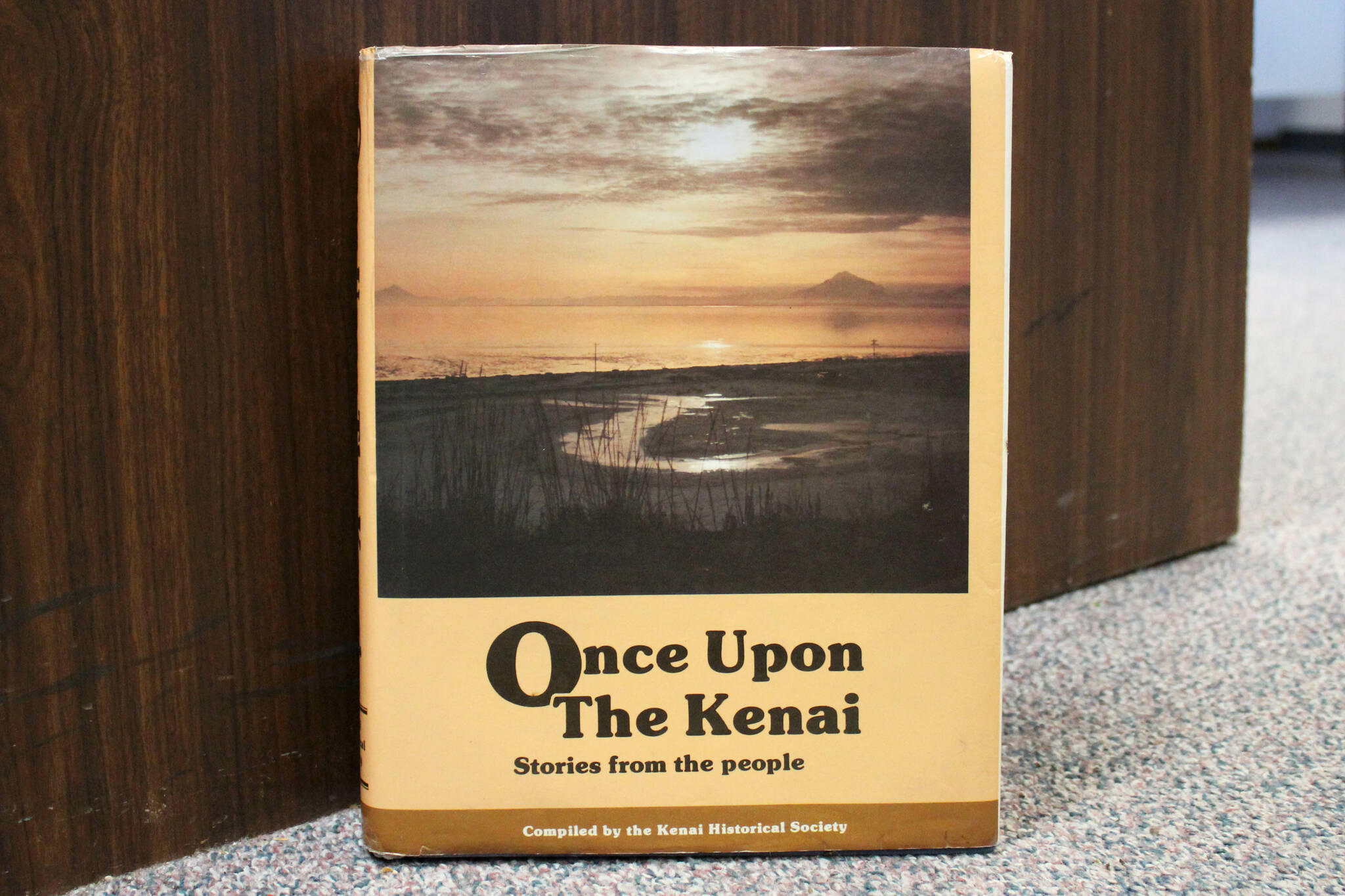 A copy of “Once Upon the Kenai: Stories from the People” rests against a desk inside the Peninsula Clarion’s offices on Wednesday, Aug. 3, 2022, in Kenai, Alaska. (Ashlyn O’Hara/Peninsula Clarion)