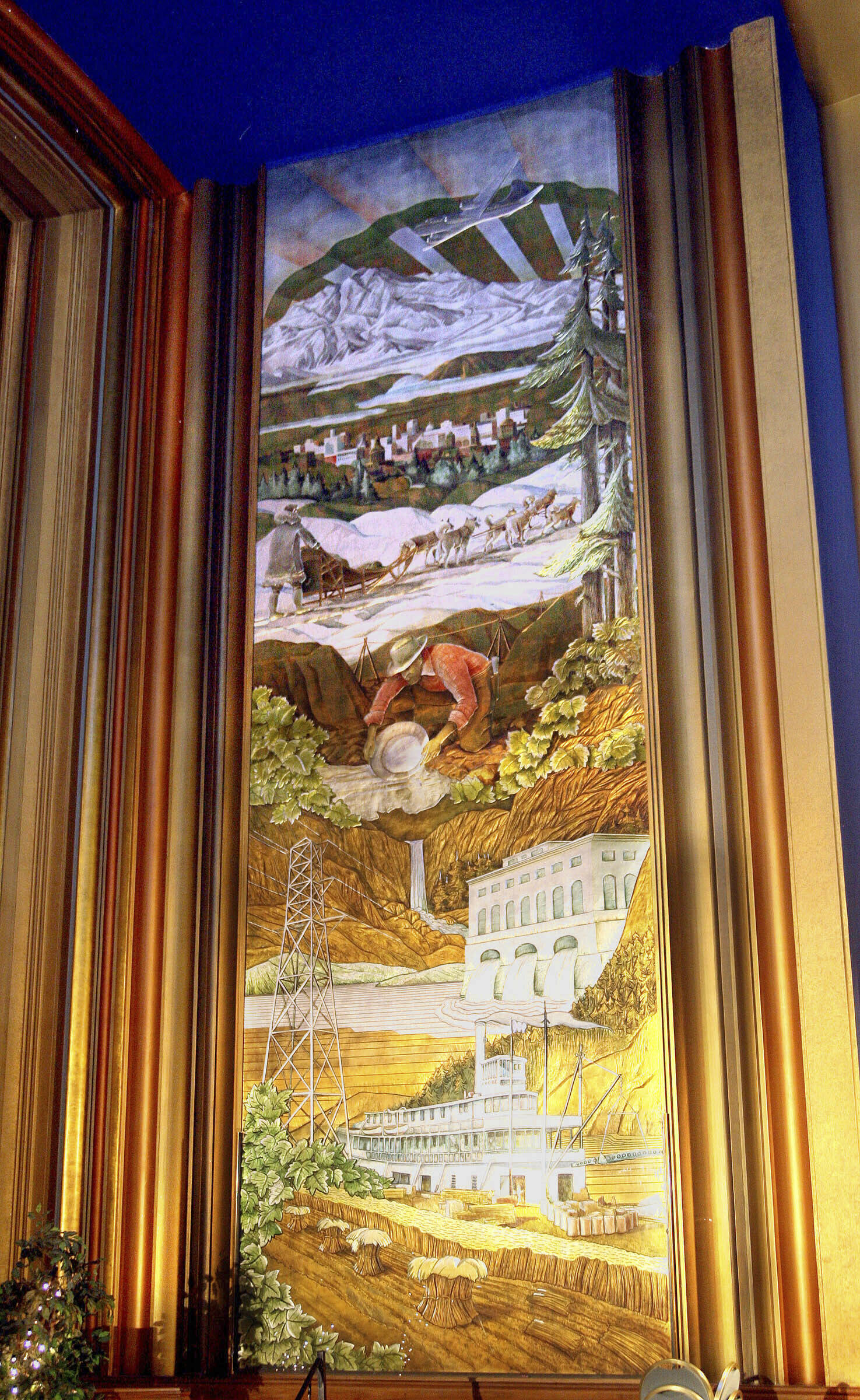 One of the gold- and silver-leaf murals of Alaska wildlife, industries and Mount McKinley hangs in the main room of the 4th Avenue Theatre in Anchorage, Alaska, on March 29, 2006. Demolition will begin in August 2022 on a once-opulent downtown Anchorage movie theater designed by the architect of Hollywood’s famed Pantages Theater. The 4th Avenue Theatre with nearly 1,000 seats opened in 1947, and it withstood the second most powerful earthquake ever recorded. (AP Photo/Al Grillo, File)