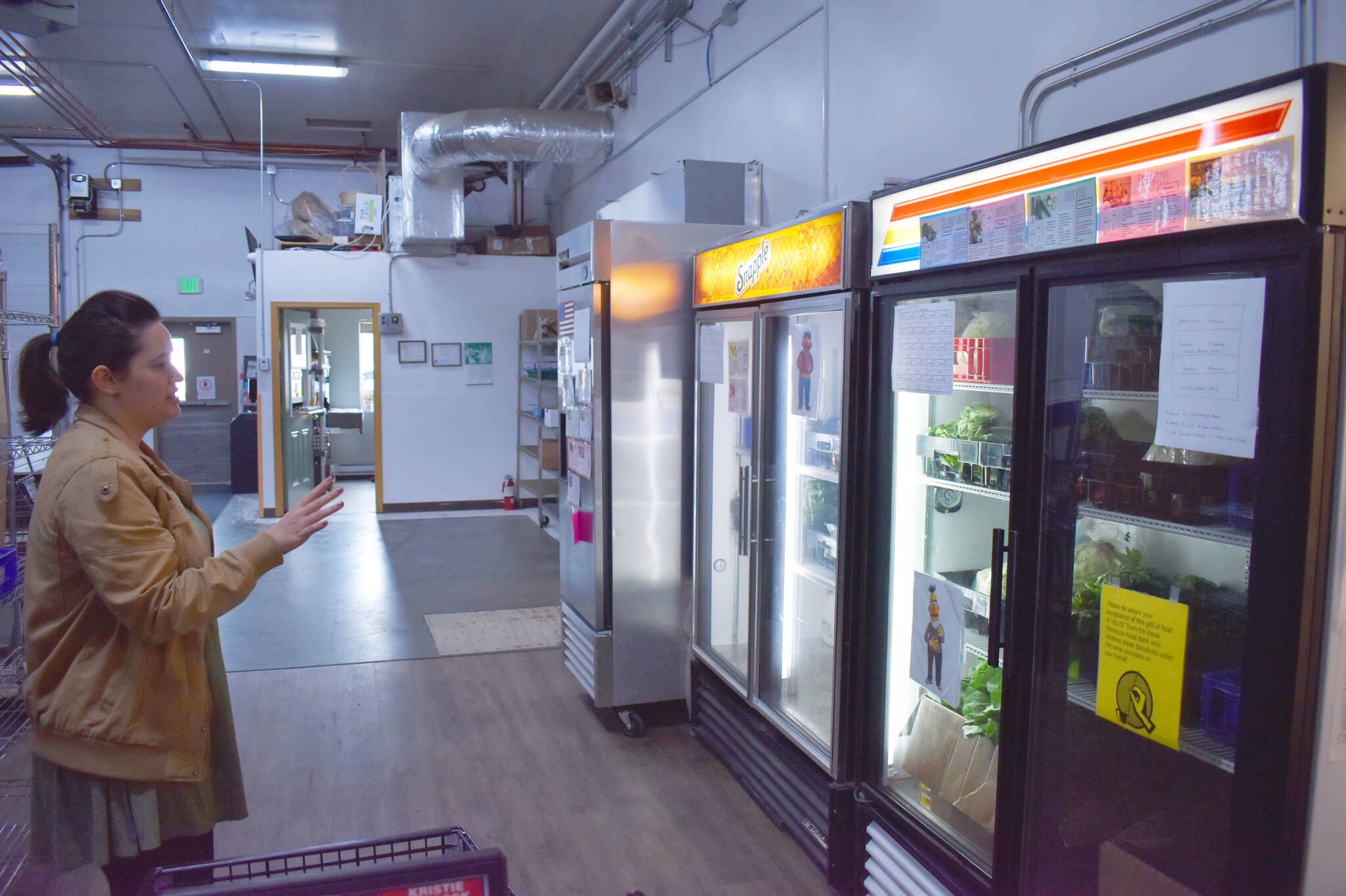 Lilly Murray, Kenai Peninsula Food Bank donations and communications manager, gives a tour of food stored at the facility on Aug. 4, 2022, in Soldotna, Alaska.