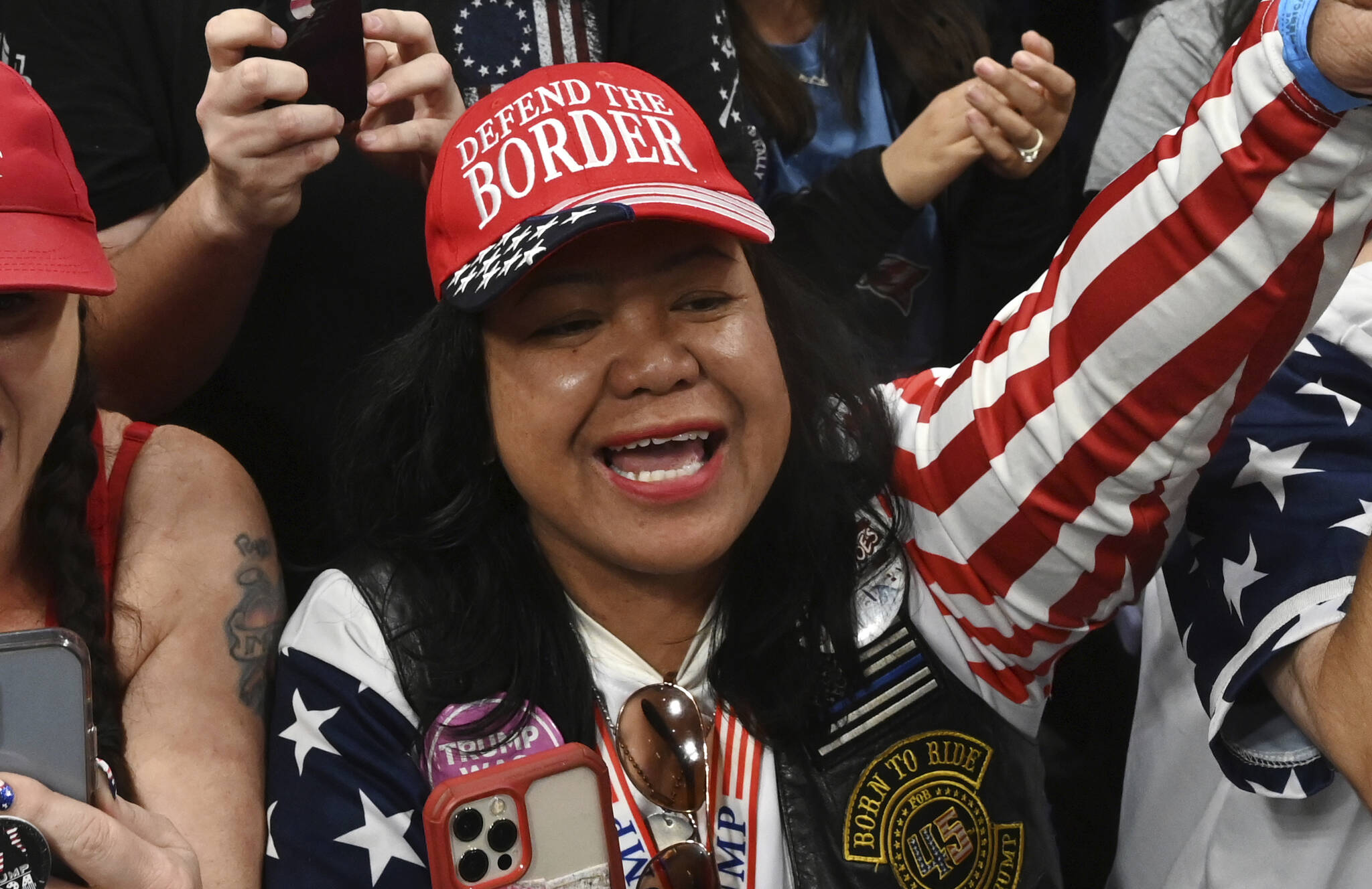 Mimi Israelah, center, cheers for Donald Trump inside the Alaska Airlines Center in Anchorage, Alaska, during a rally Saturday July 9, 2022. Two Anchorage police officers violated department policy during a traffic stop last month when Israelah, in town for a rally by former President Donald Trump showed a “white privilege card” instead of a driver’s license and was not ticketed. (Bill Roth/Anchorage Daily News via AP, File)