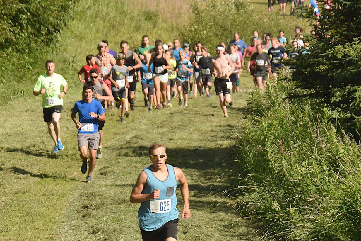 Bradley Walters leads the pack up Angle Hill on Wednesday, July 18, 2018, at the Salmon Run Series at Tsalteshi Trails. (Photo by Jeff Helminiak/Peninsula Clarion)