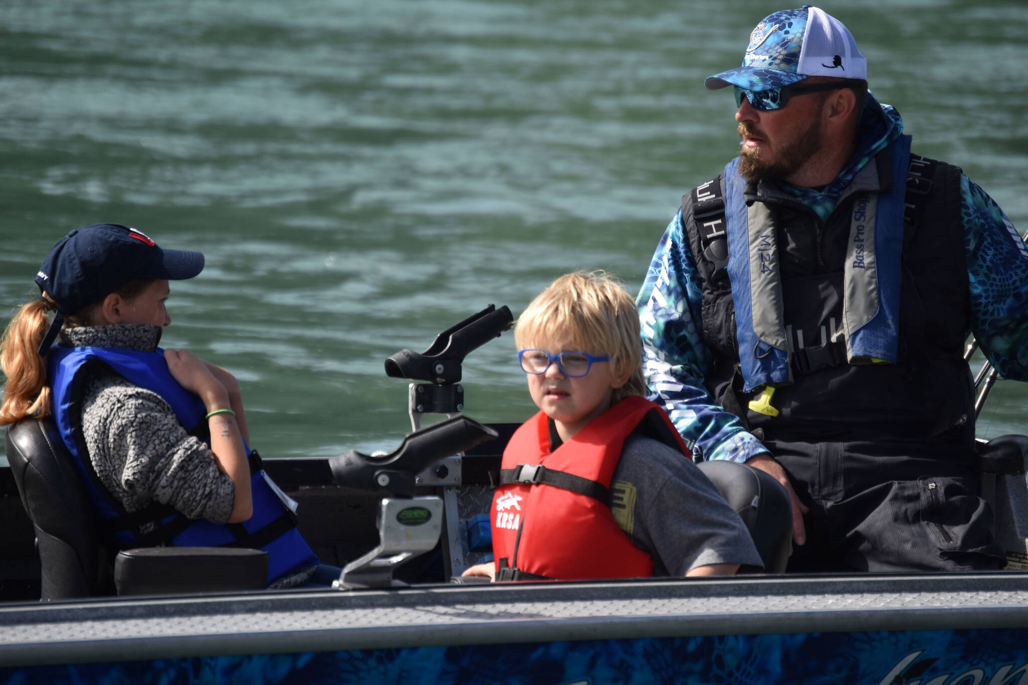 A fishing guide takes children and chaperones out on the Kenai River during the Kenai River Junior Classic in Soldotna, Alaska, on Aug. 10, 2022. (Jake Dye/Peninsula Clarion)