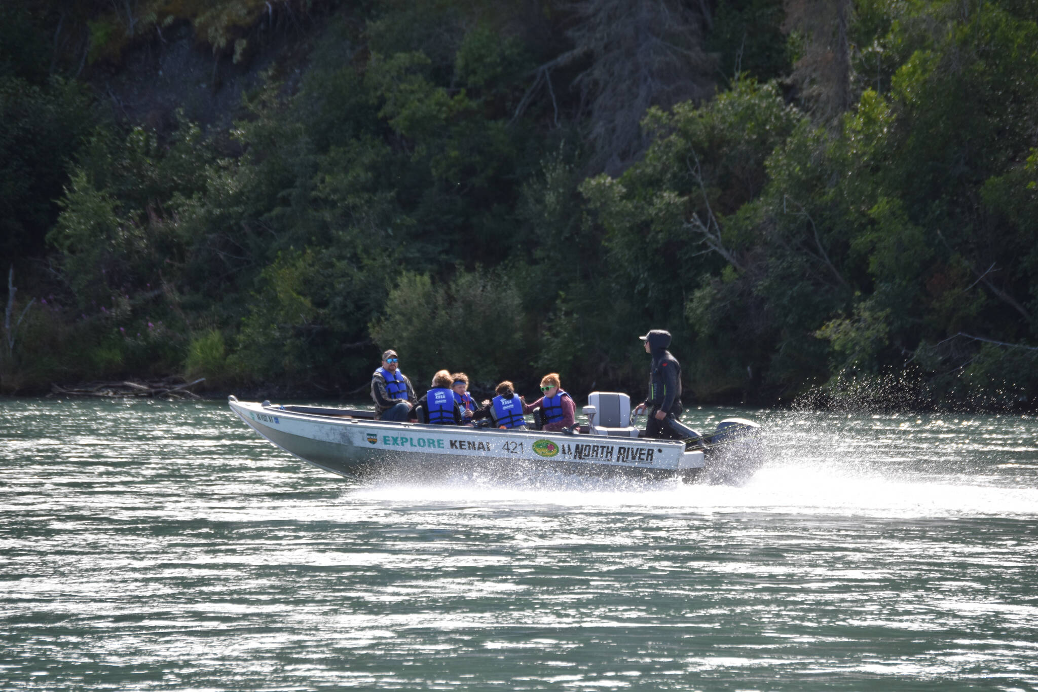 Children are whisked away on a fishing boat at the Kenai River Junior Classic in Soldotna, Alaska, on Aug. 10, 2022. (Jake Dye/Peninsula Clarion)