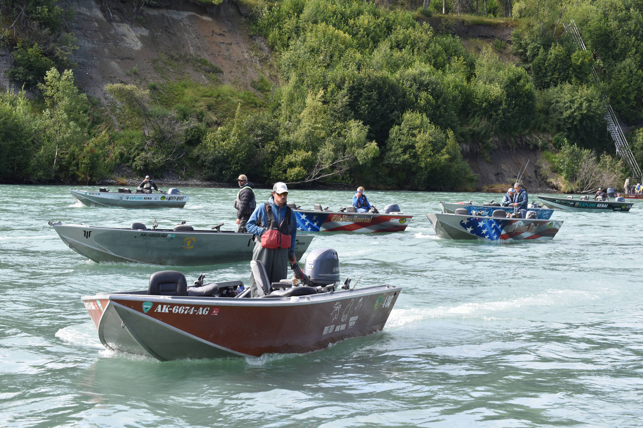 Boats are staged to pick up children at the Kenai River Junior Classic in Soldotna, Alaska, on Aug. 10, 2022. 25 boats picked up more than 90 kids. (Jake Dye/Peninsula Clarion)