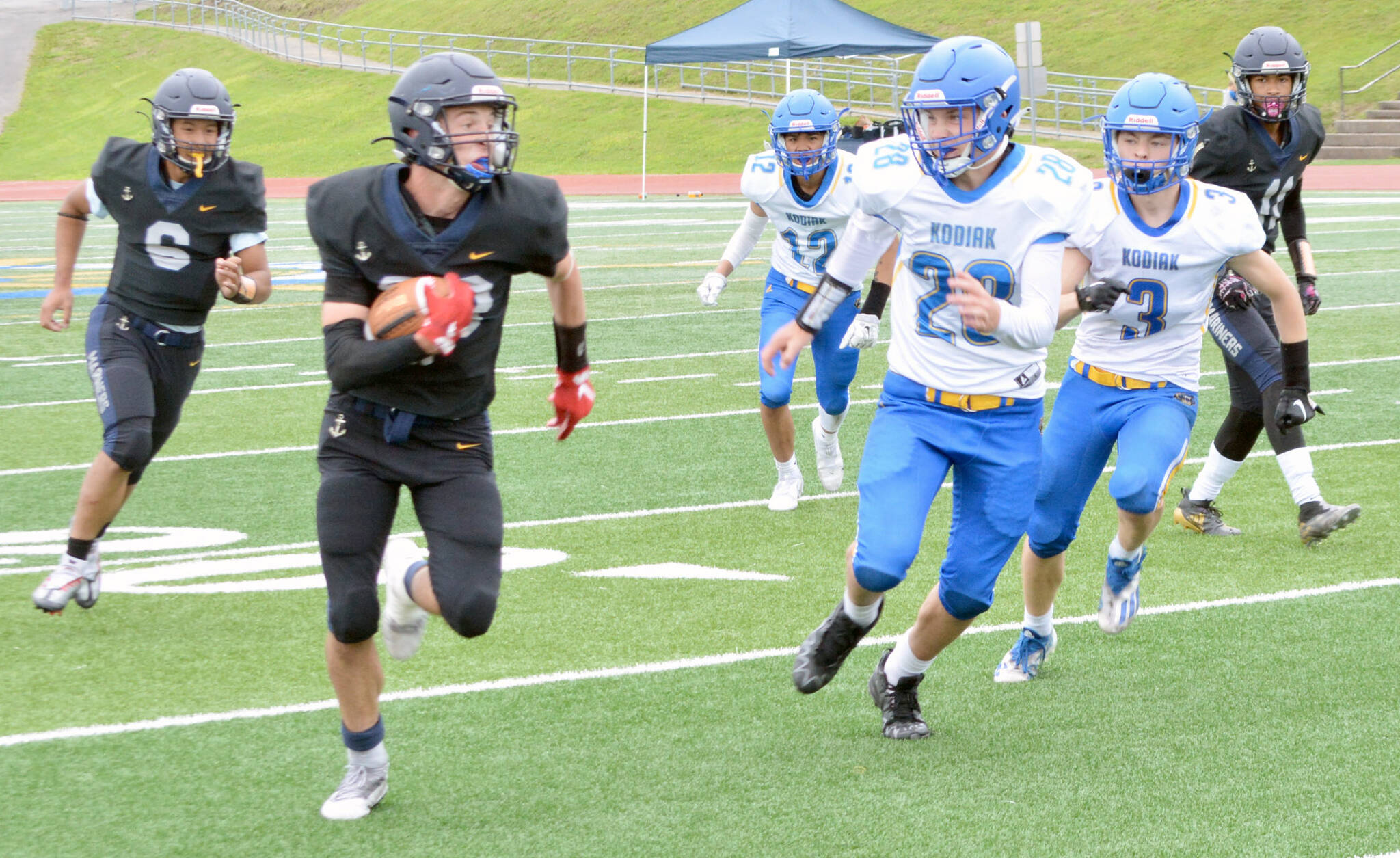 Homer’s Jake Tappan rushes against Kodiak on Saturday, Aug. 13, 2022, at Homer High School in Homer, Alaska. (Photo by Charlie Menke/Homer News)