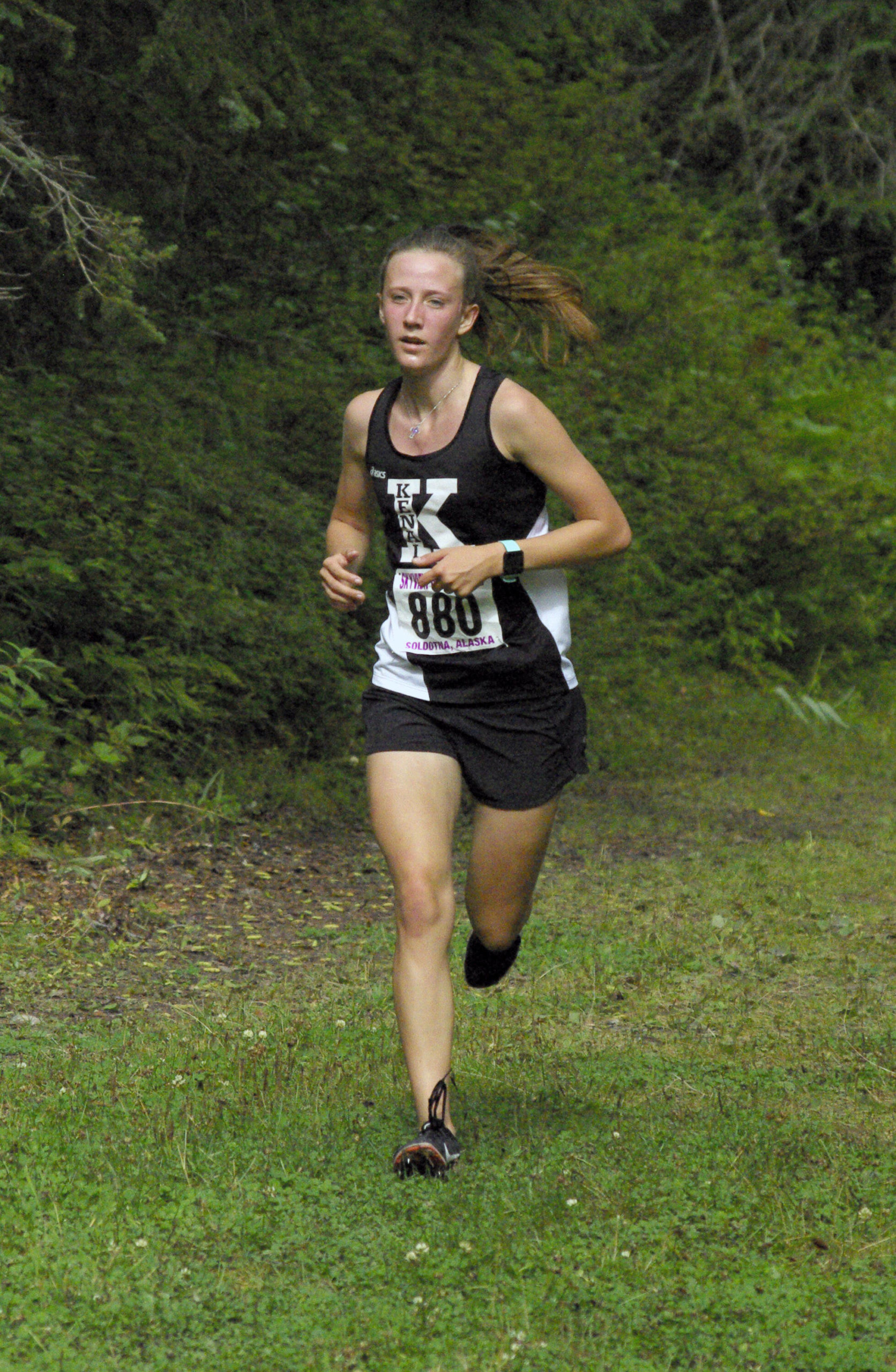 Kenai Central senior Jayna Boonstra runs to victory in a Kenai-Soldotna dual meet Monday, Aug. 15, 2022, at Tsalteshi Trails just outside of Soldotna, Alaska. (Photo by Jeff Helminiak/Peninsula Clarion)