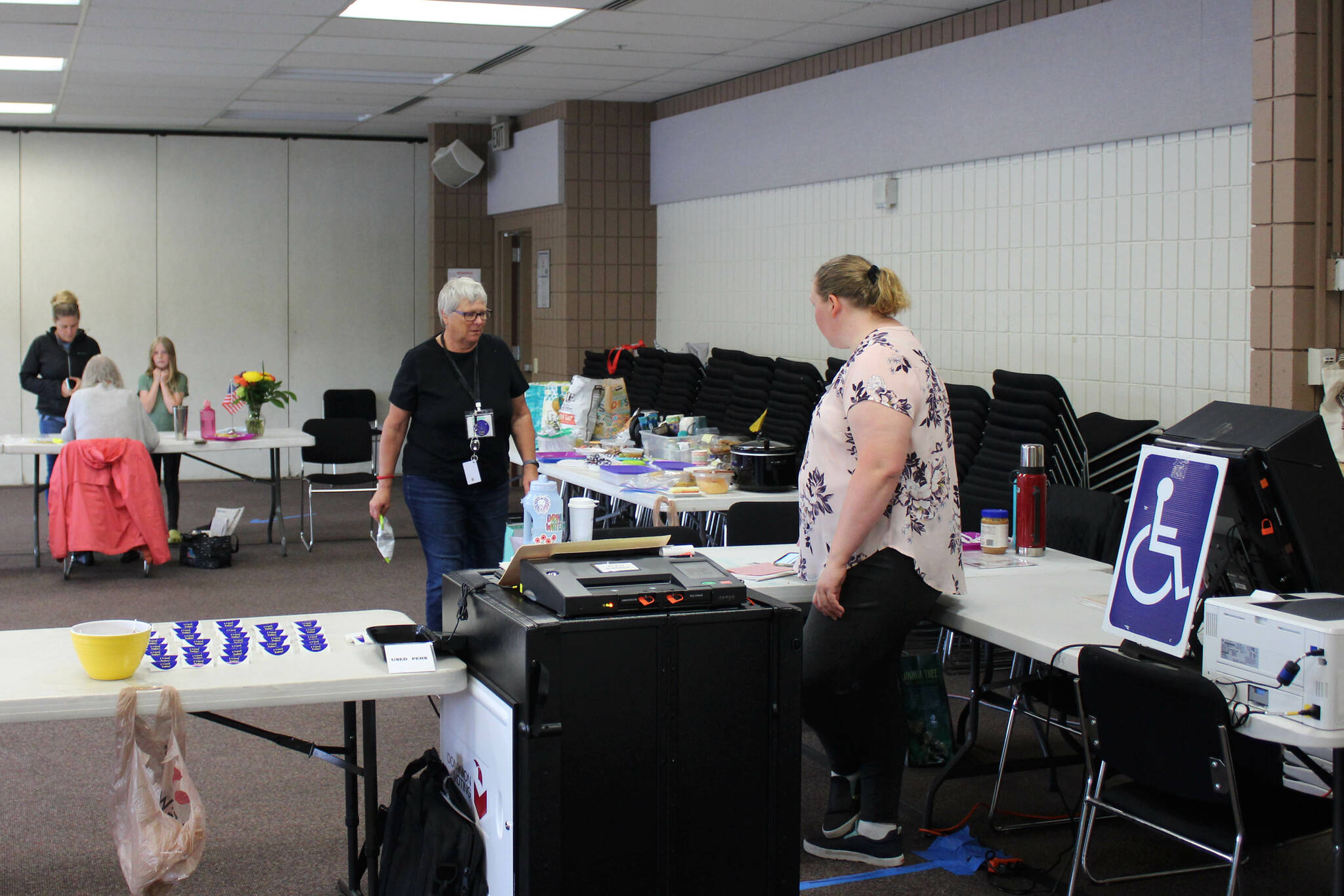 Pollworkers Carol Louthan (center) and Harmony Bolden (right) work at the Soldotna Regional Sports Complex on Tuesday, Aug. 16, 2022 in Soldotna, Alaska. (Ashlyn O’Hara/Peninsula Clarion)