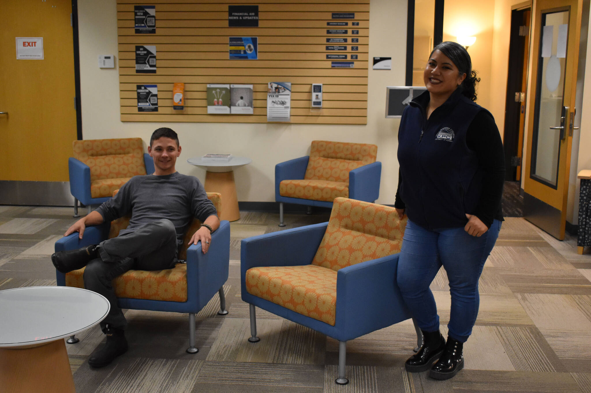 Alex LeClair and a representative of the KPC Financial Aid Office in the Kenai Peninsula College Student Services Office on Aug. 18, 2022 in Soldotna, Alaska. (Jake Dye/Peninsula Clarion)