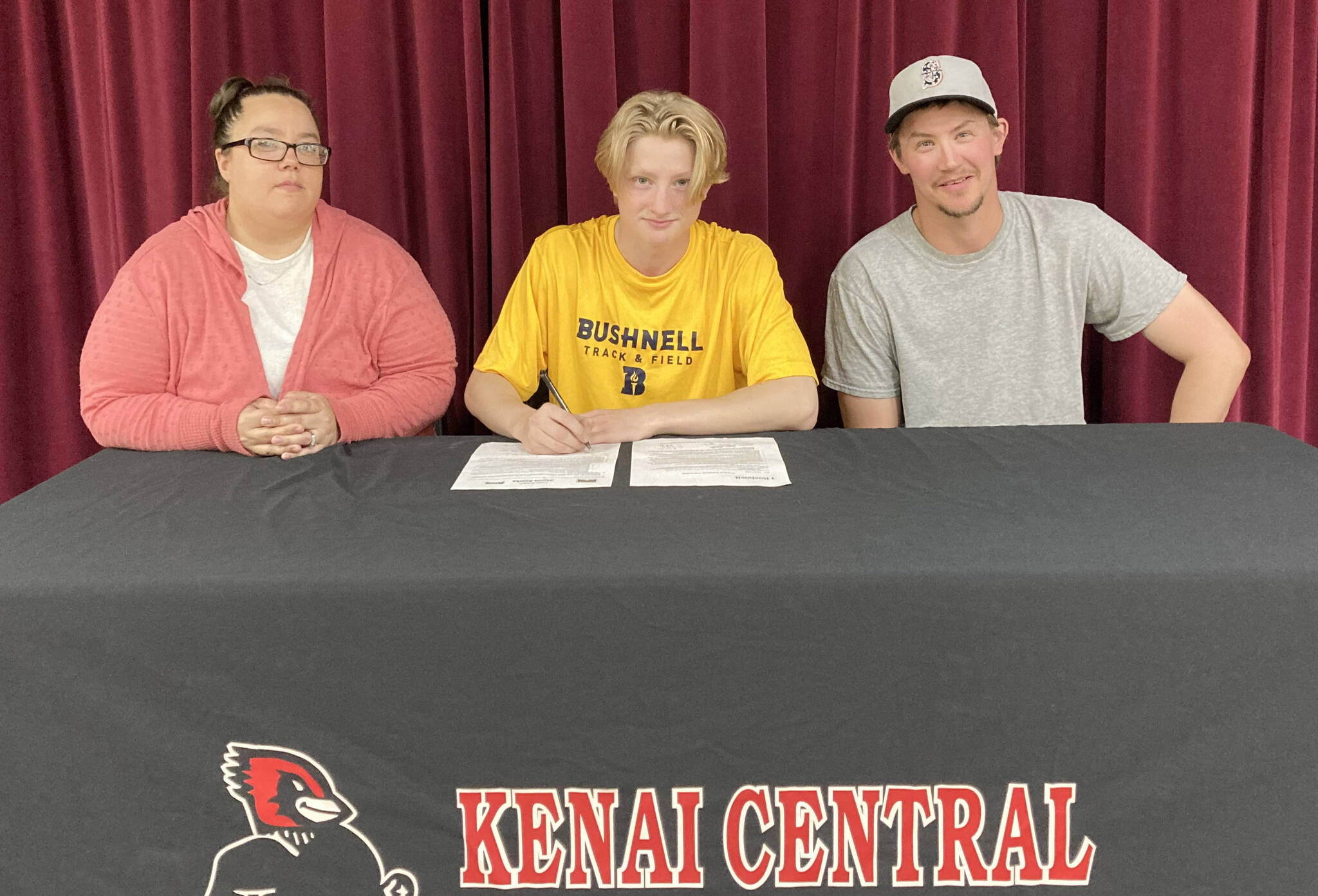 James Sparks, center, signs a National Letter of Intent with his parents, Angela and Jacob Sparks, on Tuesday, Aug. 16, 2022. (Photo provided)
