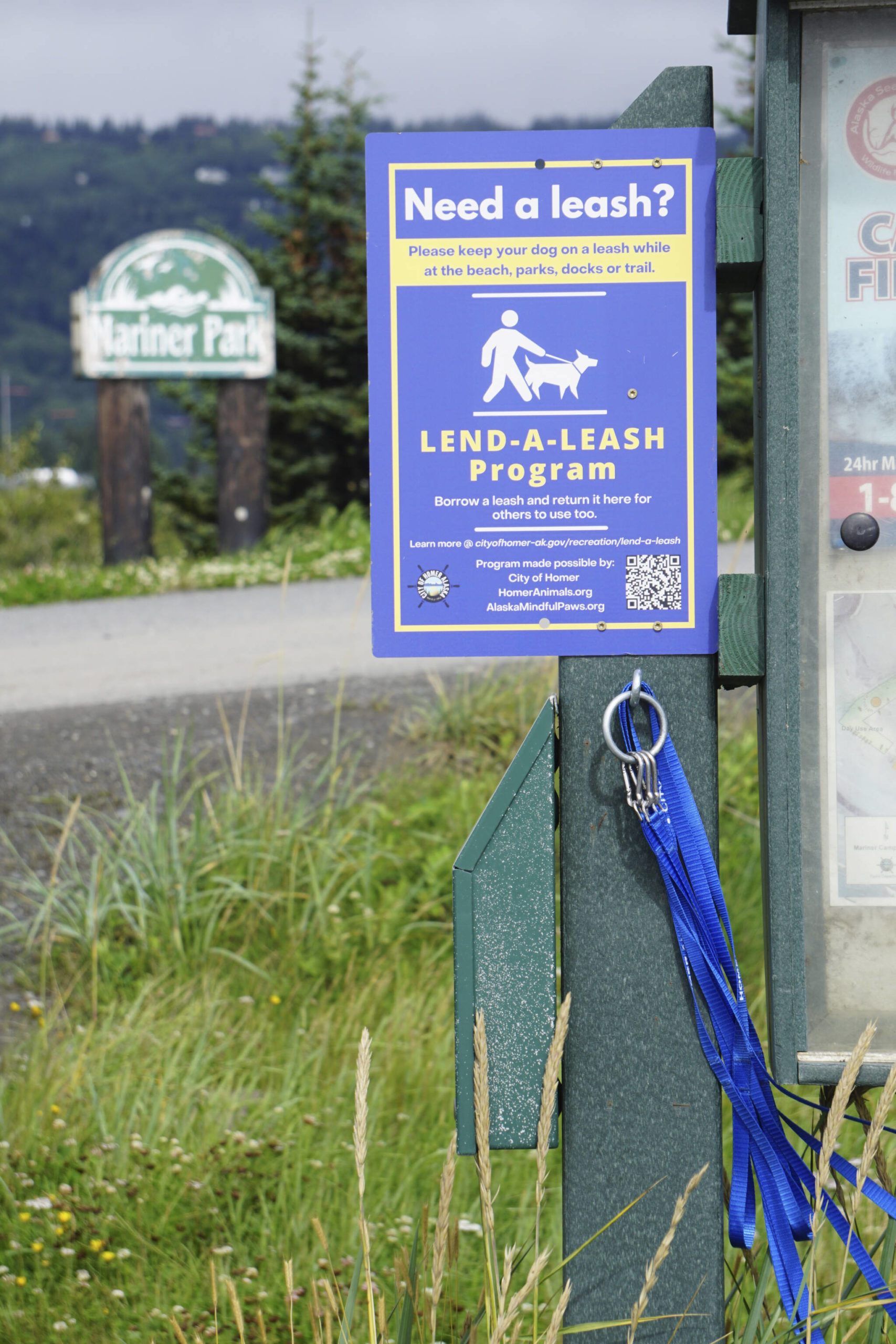 Leashes to lend hang from a kiosk at Mariner Park on Friday, Aug. 12, 2022, in Homer, Alaska. (Photo by Michael Armstrong/Homer News)