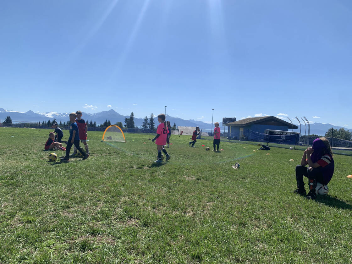 Kids playing soccer on a sunny summer day. (Photo by Charlie Menke/ Homer News)