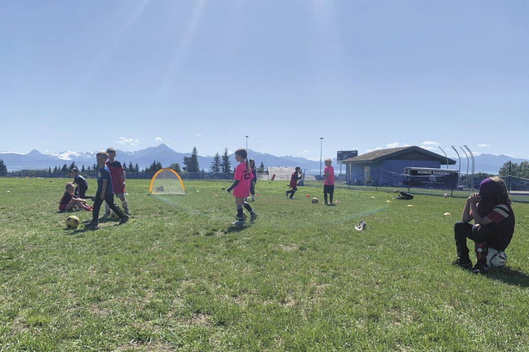Kids playing soccer on a sunny summer day. (Photo by Charlie Menke/ Homer News)