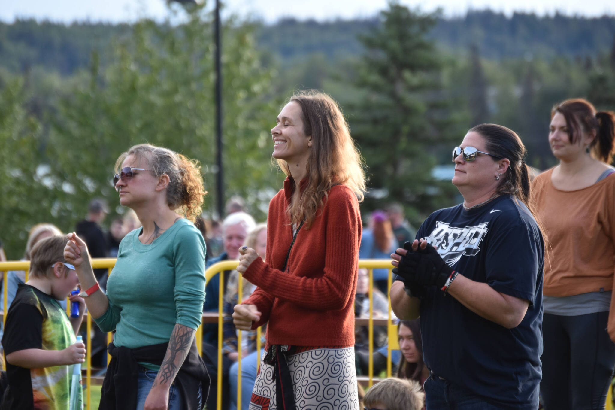 Amy Jackman (center) and others dance to music performed by Kuf Knotz and Christine Elise on Aug. 24, 2022, in Soldotna, Alaska. (Jake Dye/Peninsula Clarion)