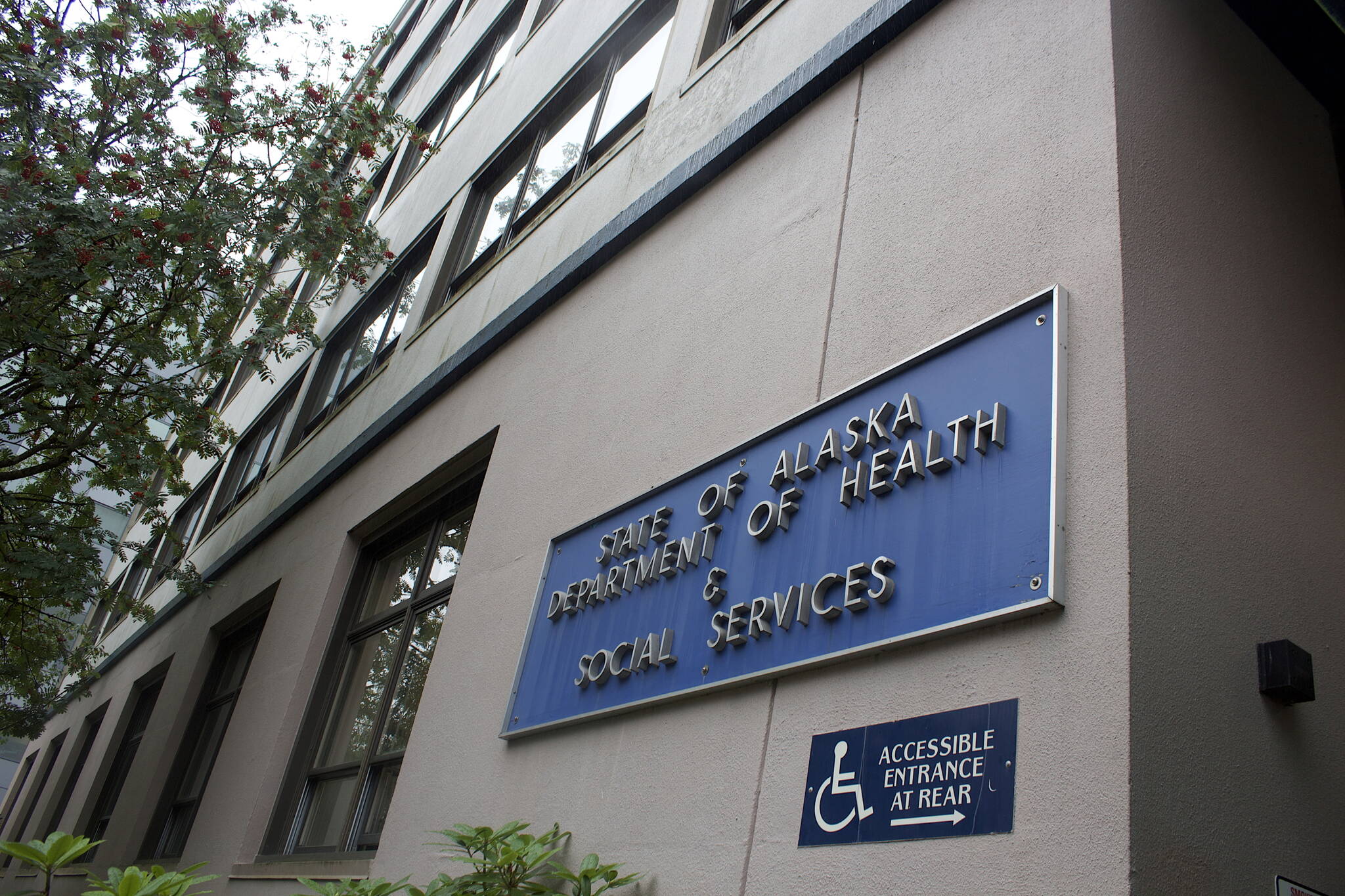 A State of Alaska Department of Health Social Services sign remains on the main building providing in Juneau providing related services, even though the agency officially split into two departments on July 1. Other signs inside the building and one next door housing some of the new departments’ services are also unchanged. Commissioners of both departments said Thursday the initial focus has been on transitioning essential services without disruption, and more publicly noticeable ones such as new signs and website updates should be occurring during the coming months. (Mark Sabbatini / Juneau Empire)