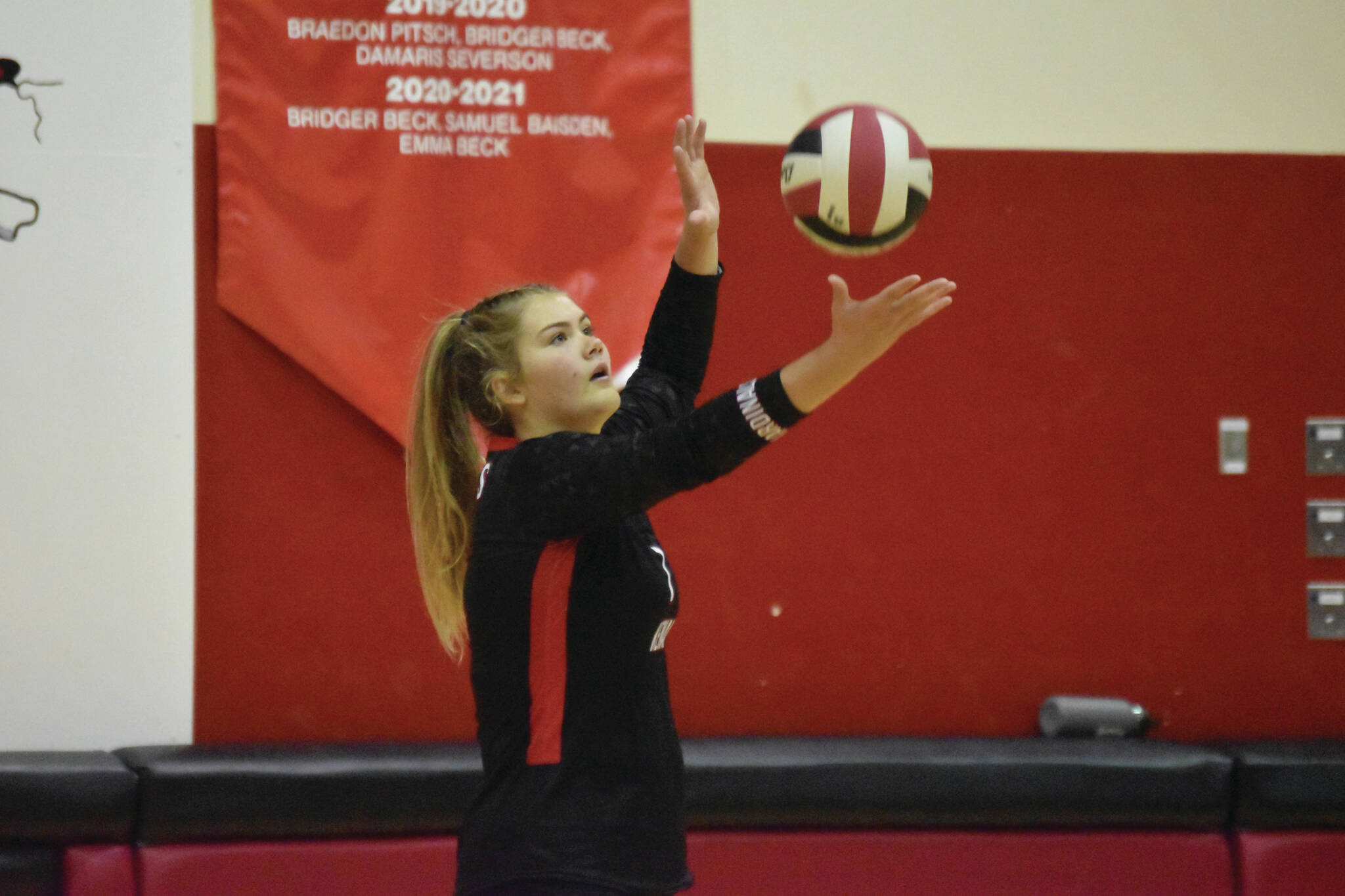 Emma Beck serves the volleyball on Aug. 25, 2022, in Kenai, Alaska. (Jake Dye/Peninsula Clarion)