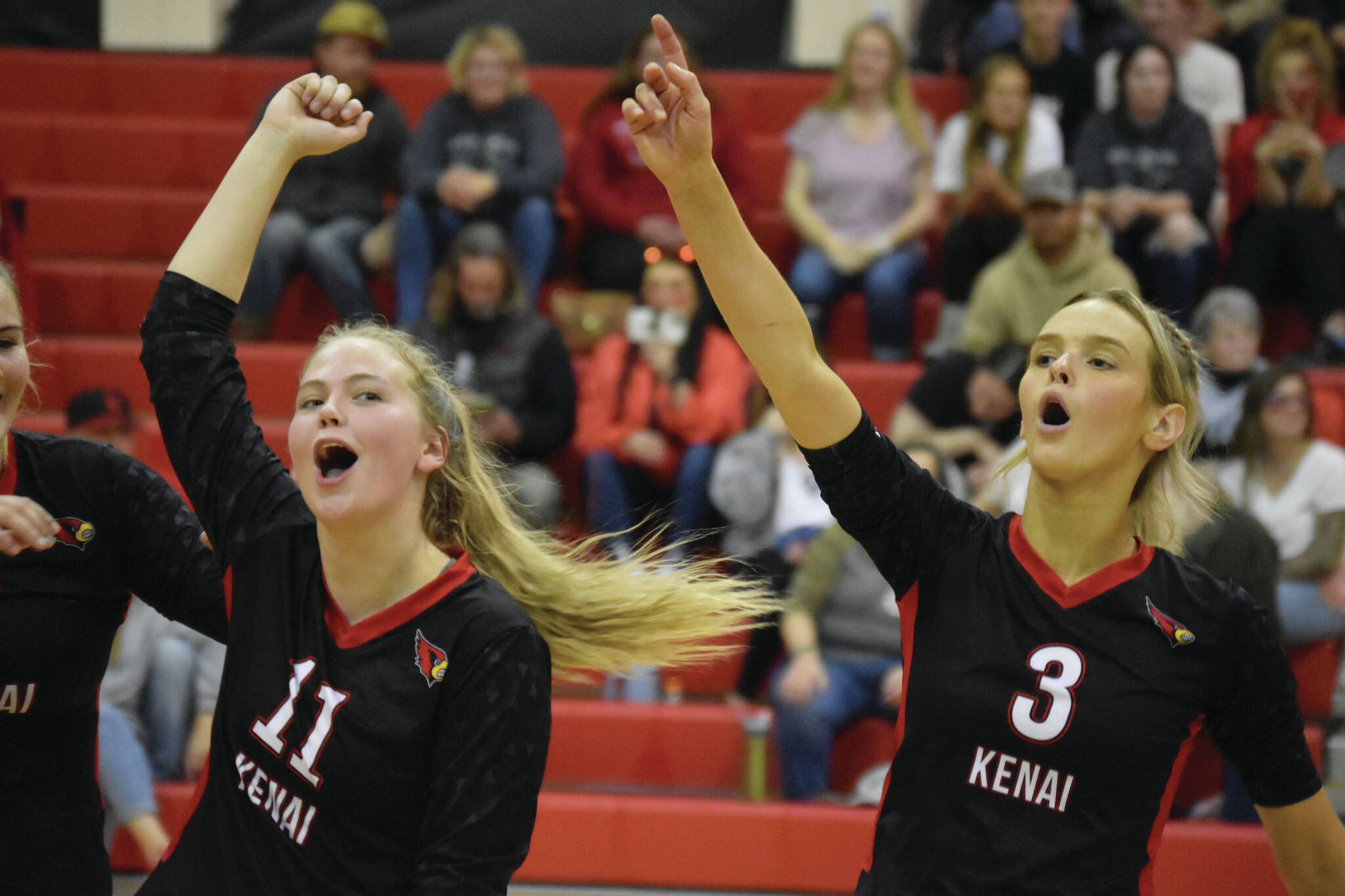 Grace Beiser and Cali Holmes celebrate a score on Aug. 25, 2022, in Kenai, Alaska. (Jake Dye/Peninsula Clarion)